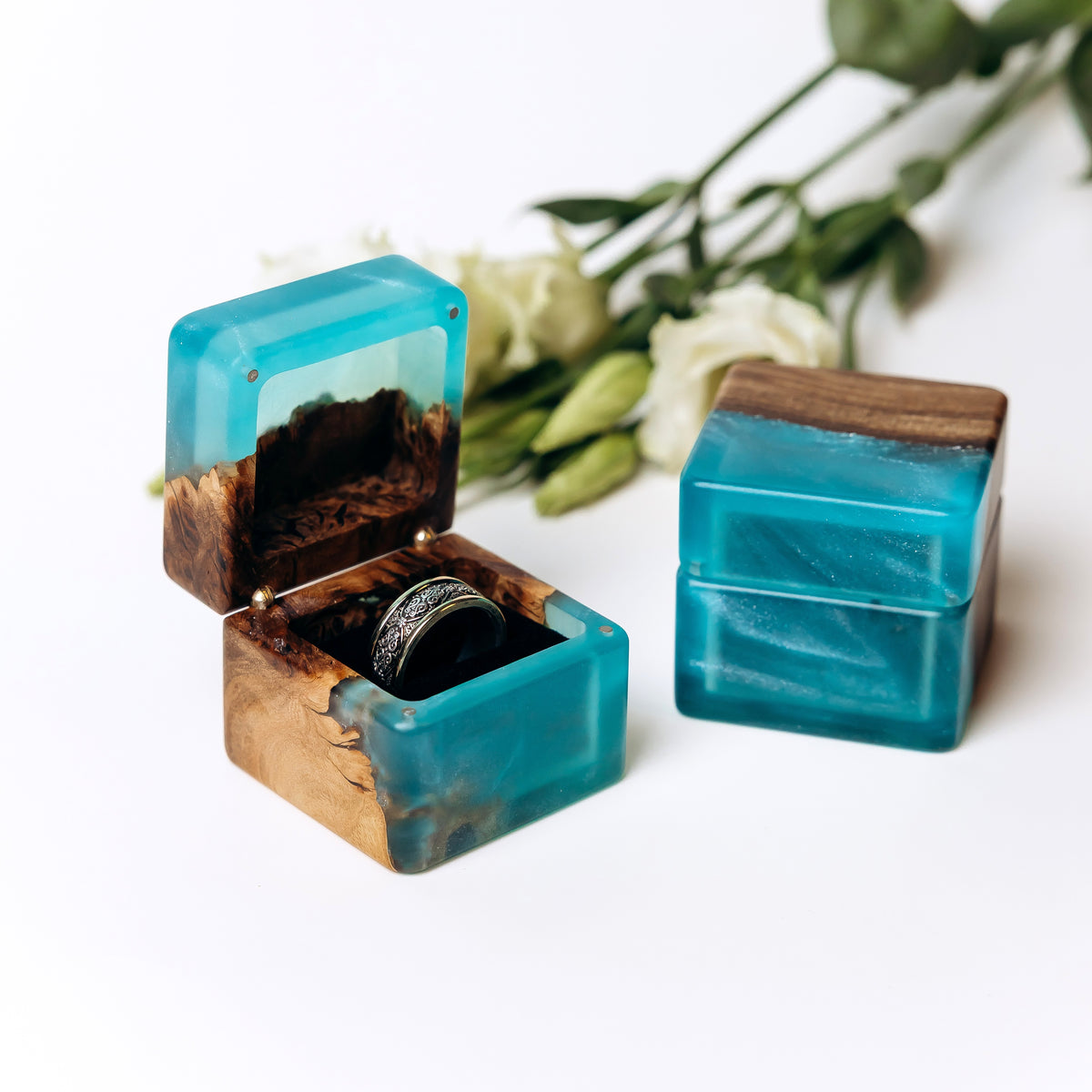 Wooden ring box in aqua blue epoxy and elm wood, shown open with a ring and closed beside it