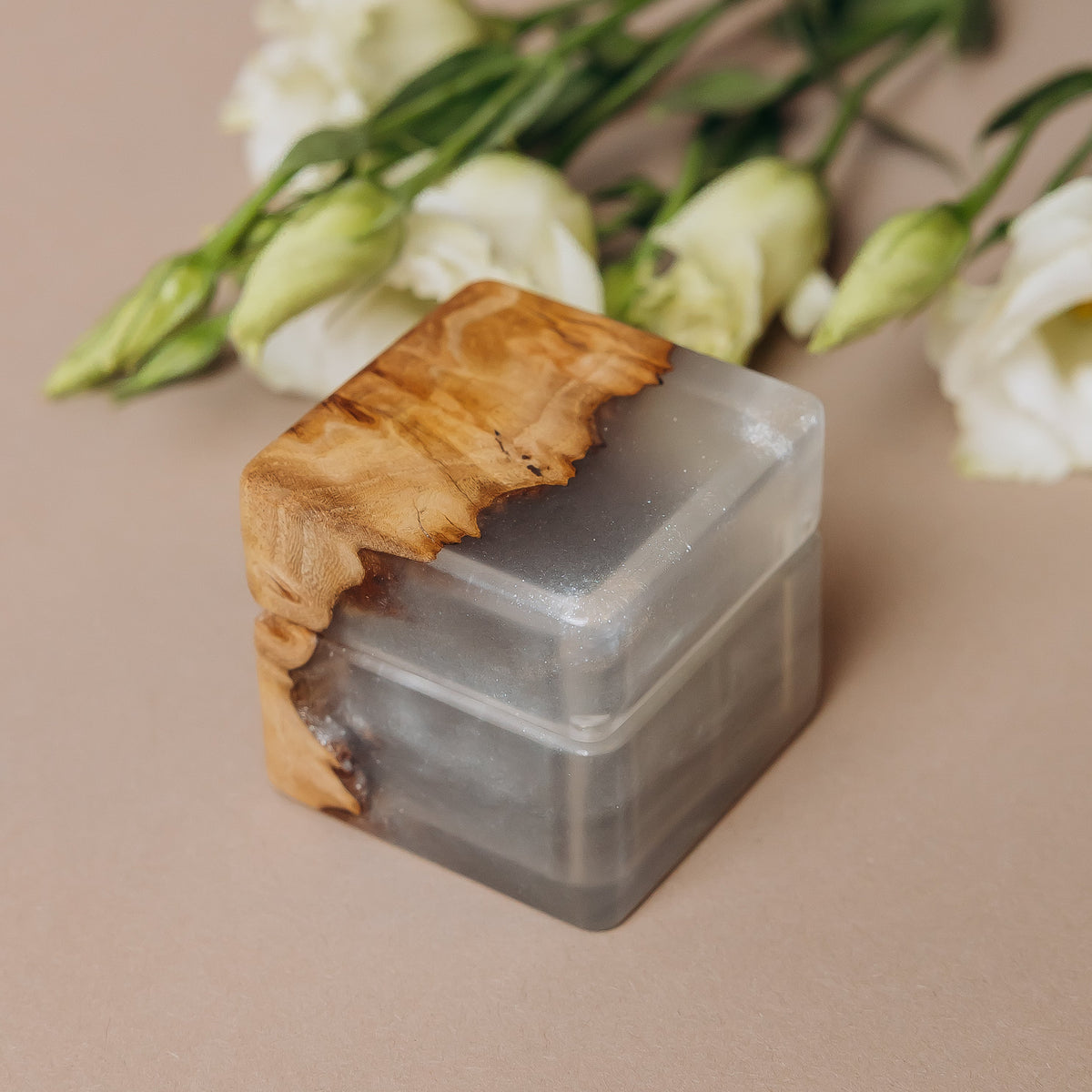 Closed platinum epoxy ring box showing the live edge where elm burl meets pearl resin