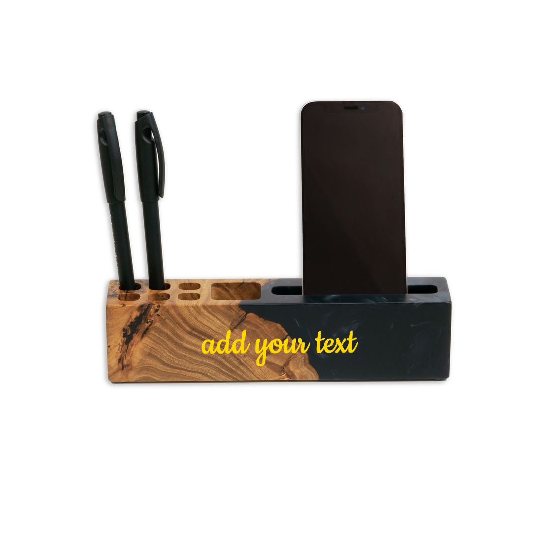 ELEMENT desk organizer in black epoxy and elm wood with a phone and pens and a gold 'add your text' engraving placeholder