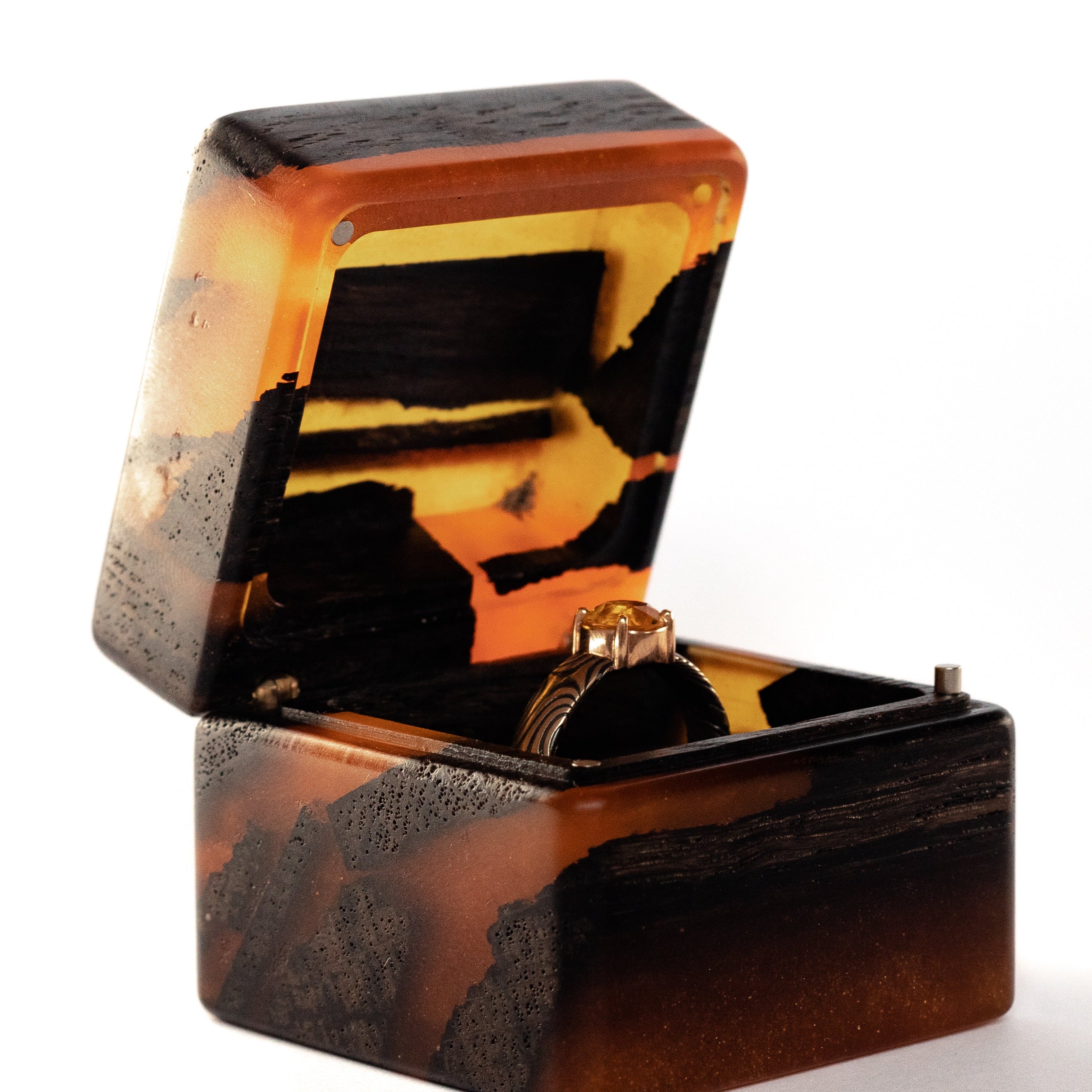 Close-up of the open amber epoxy and bog oak wood proposal ring box showing the interior ring slot