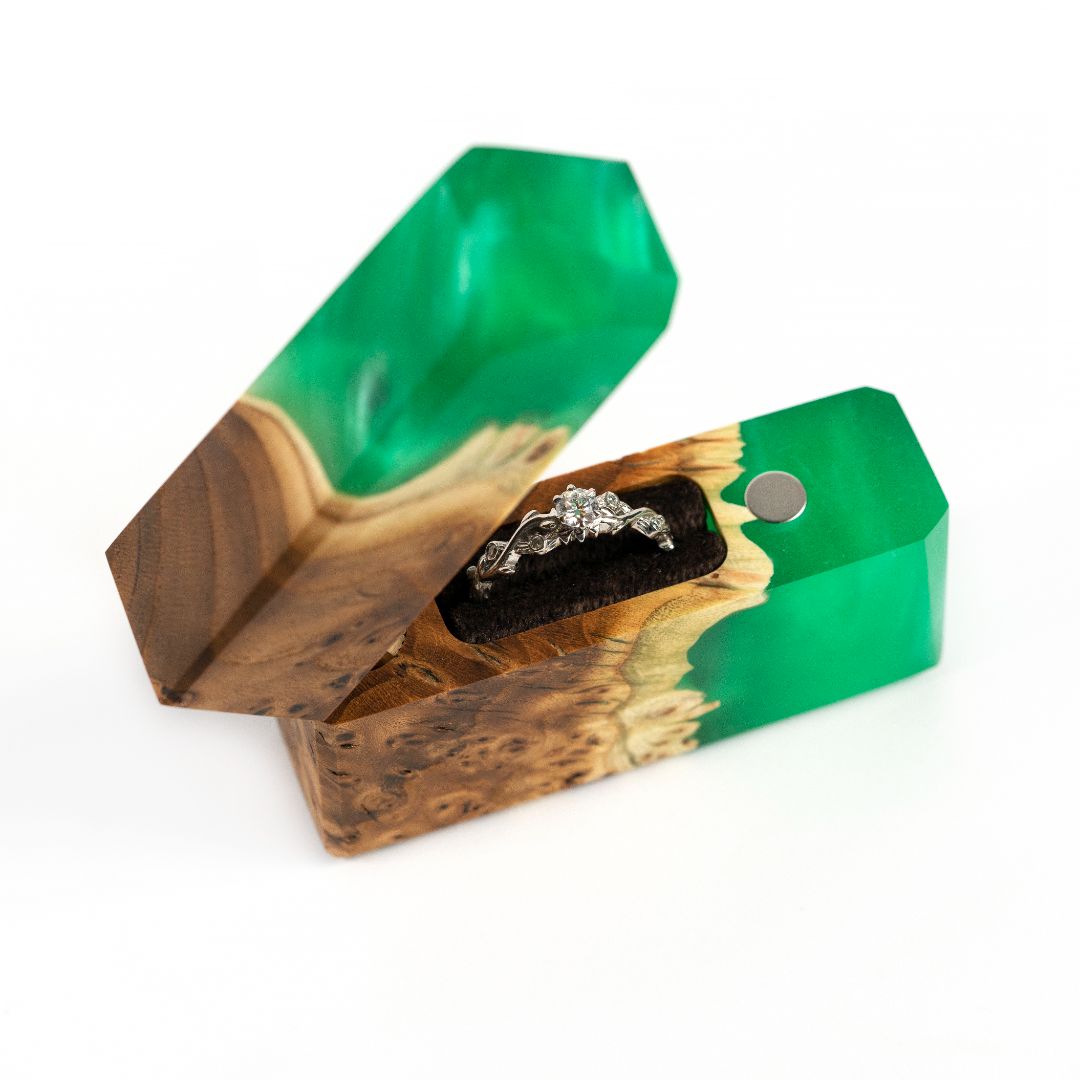 Open green epoxy and elm wood proposal ring box displayed at an angle for gift presentation