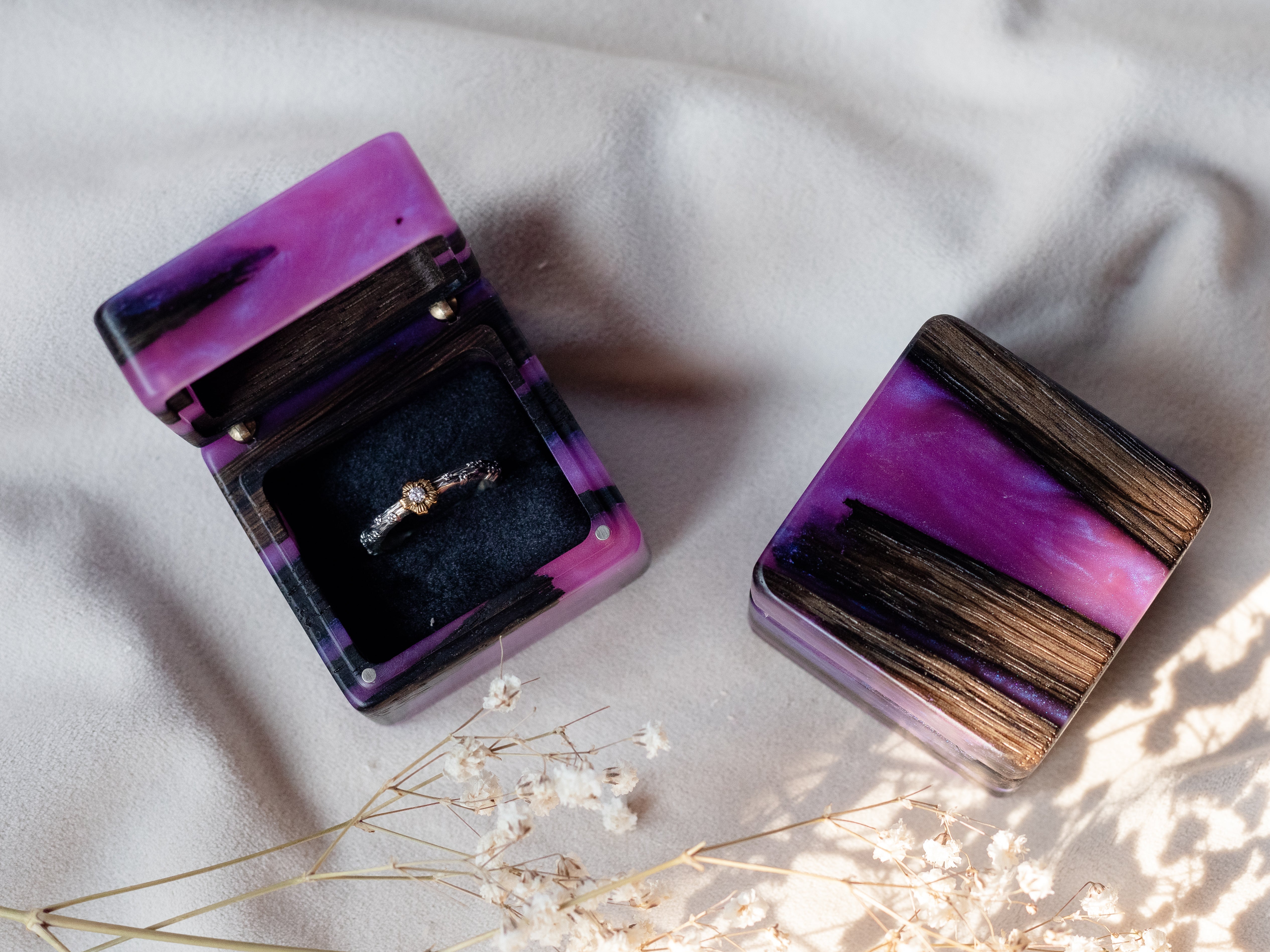 Open purple epoxy and bog oak wood proposal ring box styled with dried flowers