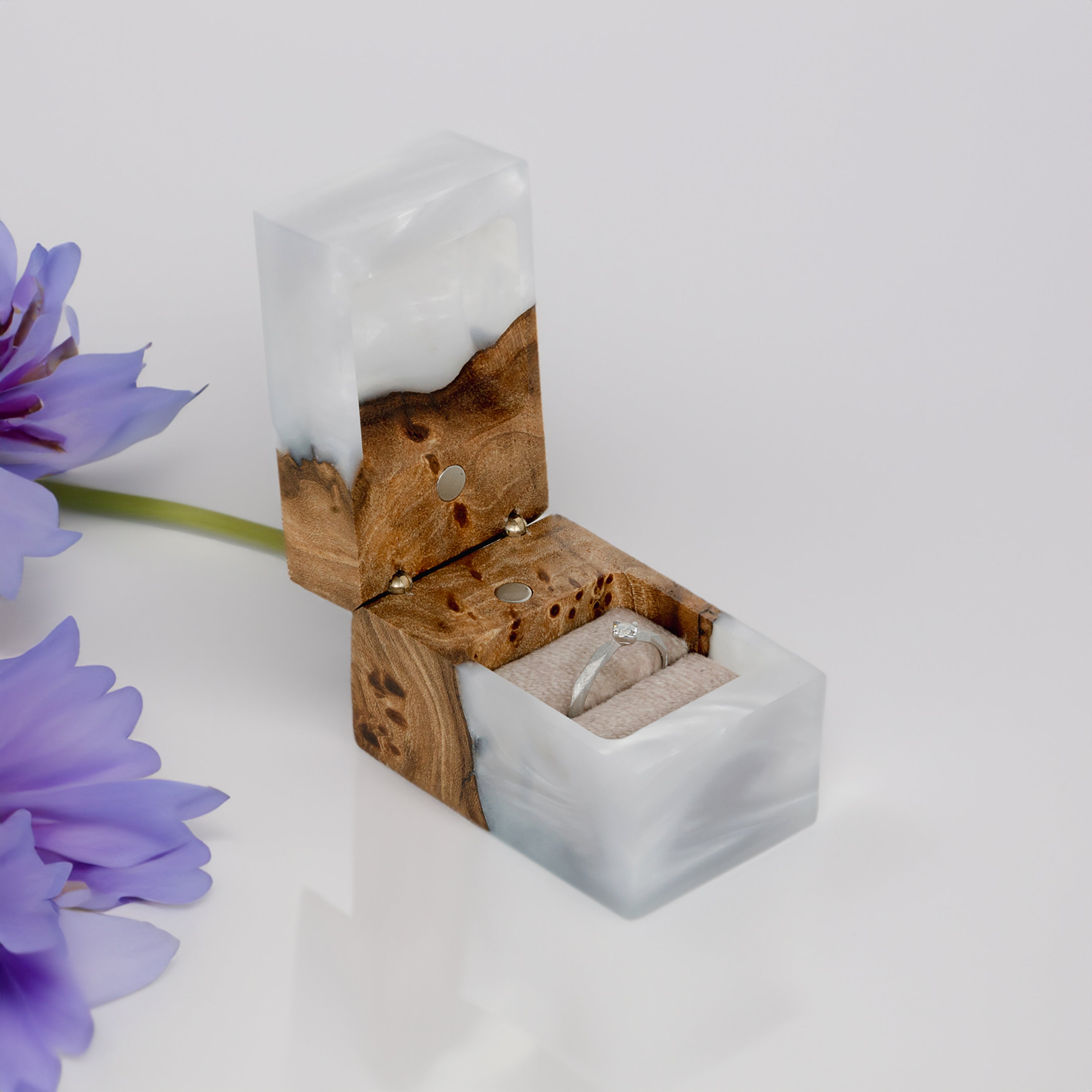 Open platinum epoxy and elm wood engagement ring box styled with decorative flowers