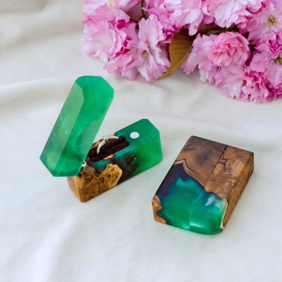 Luxury green epoxy and elm wood proposal ring box displayed with decorative flowers