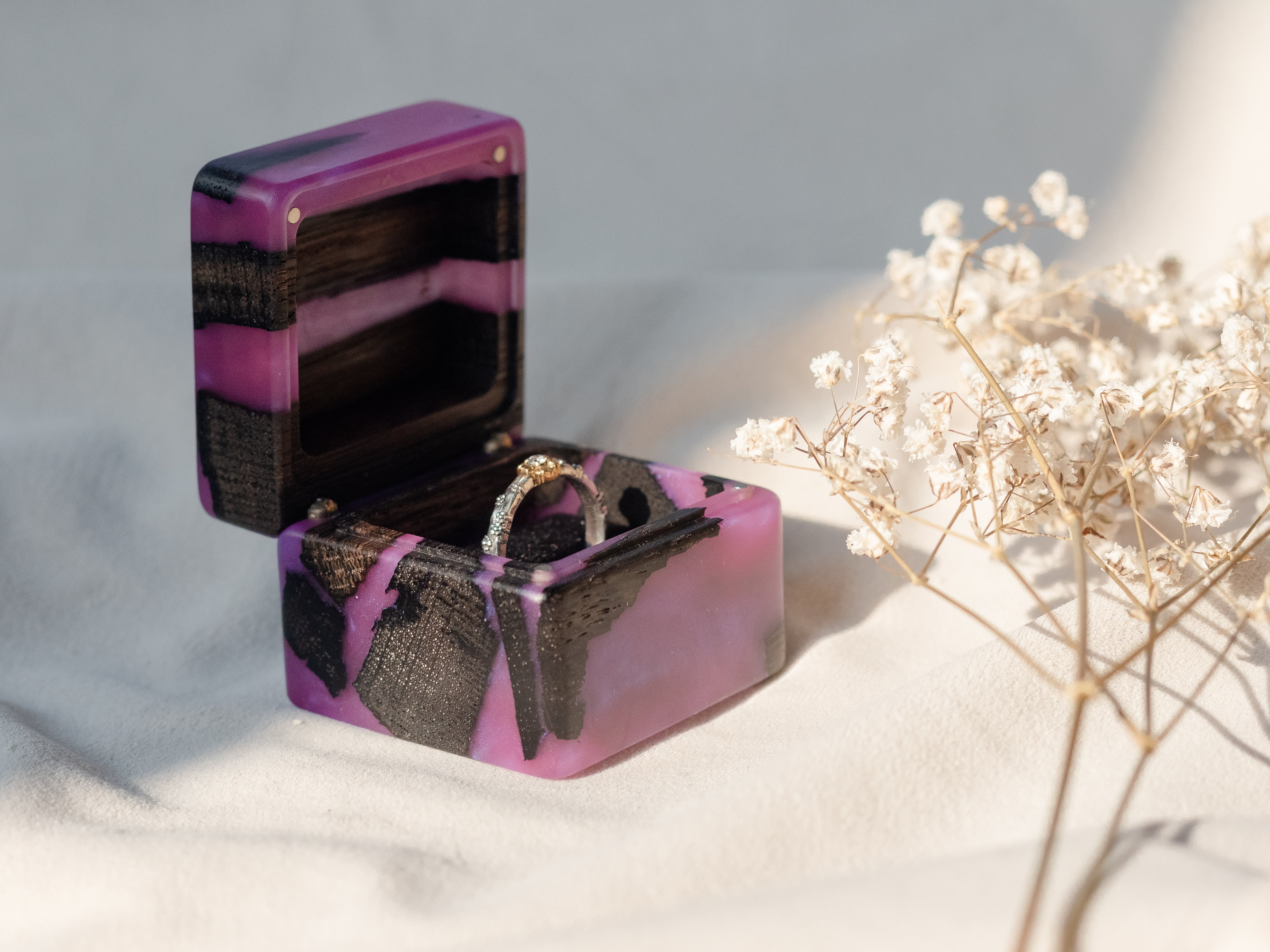 Luxury purple epoxy and bog oak wood proposal ring box displayed with dried flowers