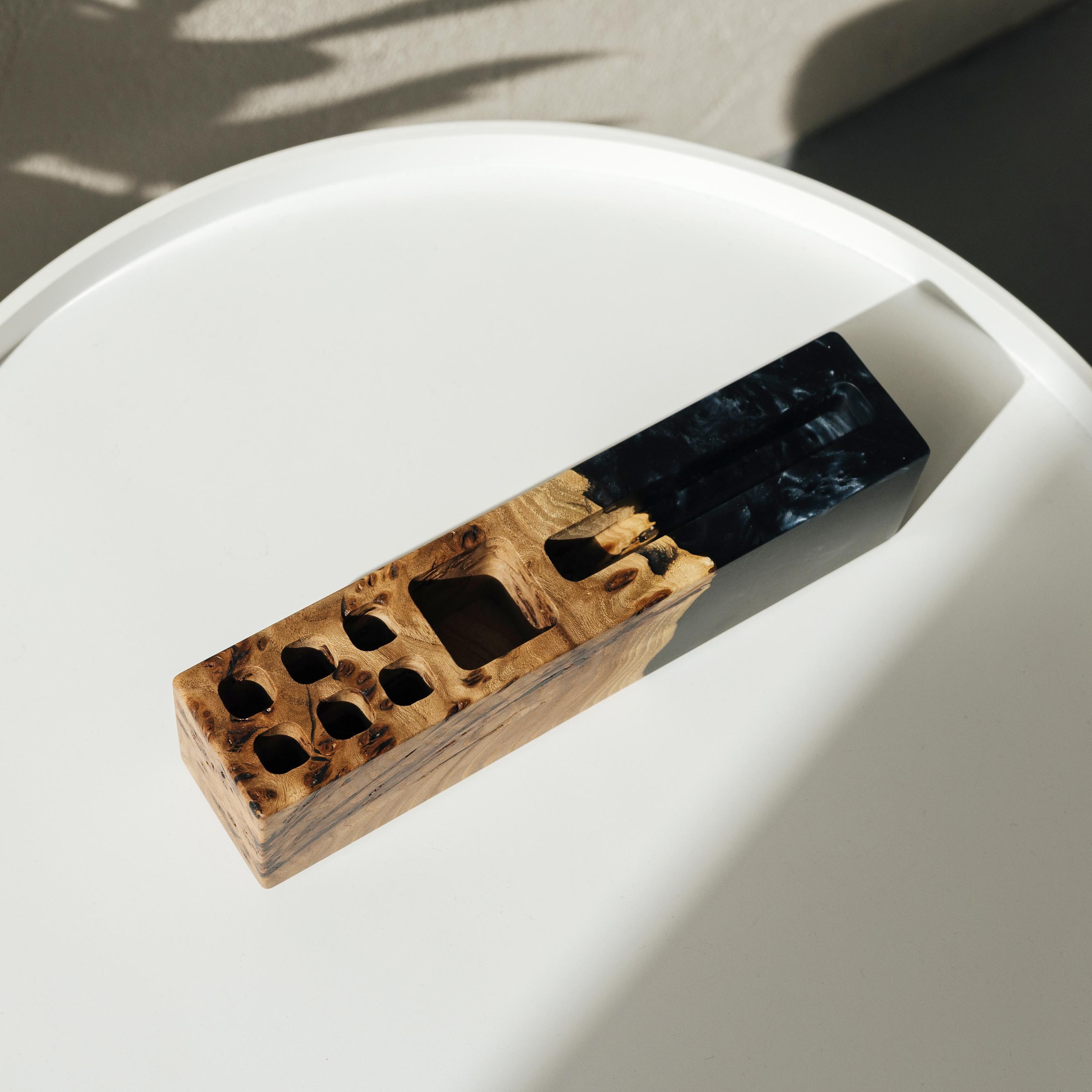 Angled view of the ELEMENT wood desk organizer handcrafted from elm wood and black epoxy resin