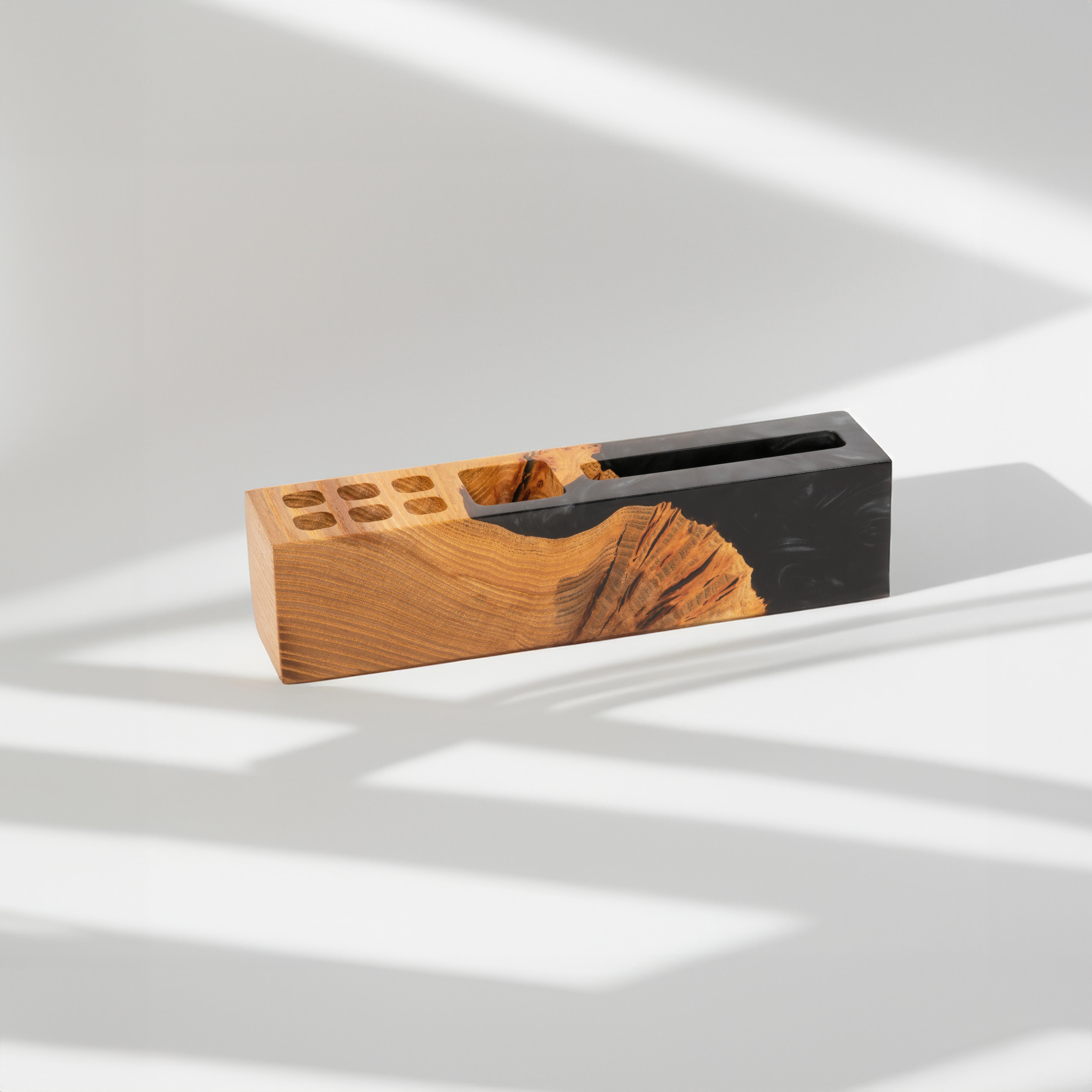 Side view of the ELEMENT wood desk organizer with phone stand and pen holder made from elm wood and black epoxy resin