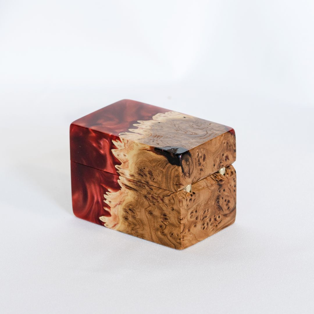 Closed engagement ring box featuring ruby epoxy and natural elm wood grain, CHORD design