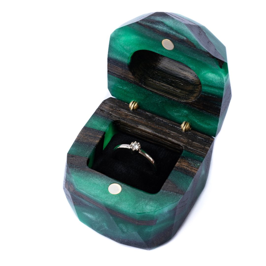 Elegant open green epoxy and bog oak wood engagement ring box photographed in a studio setting