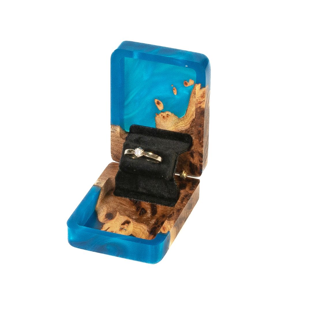 Elegant blue epoxy and elm wood proposal ring box displayed open in a studio setting