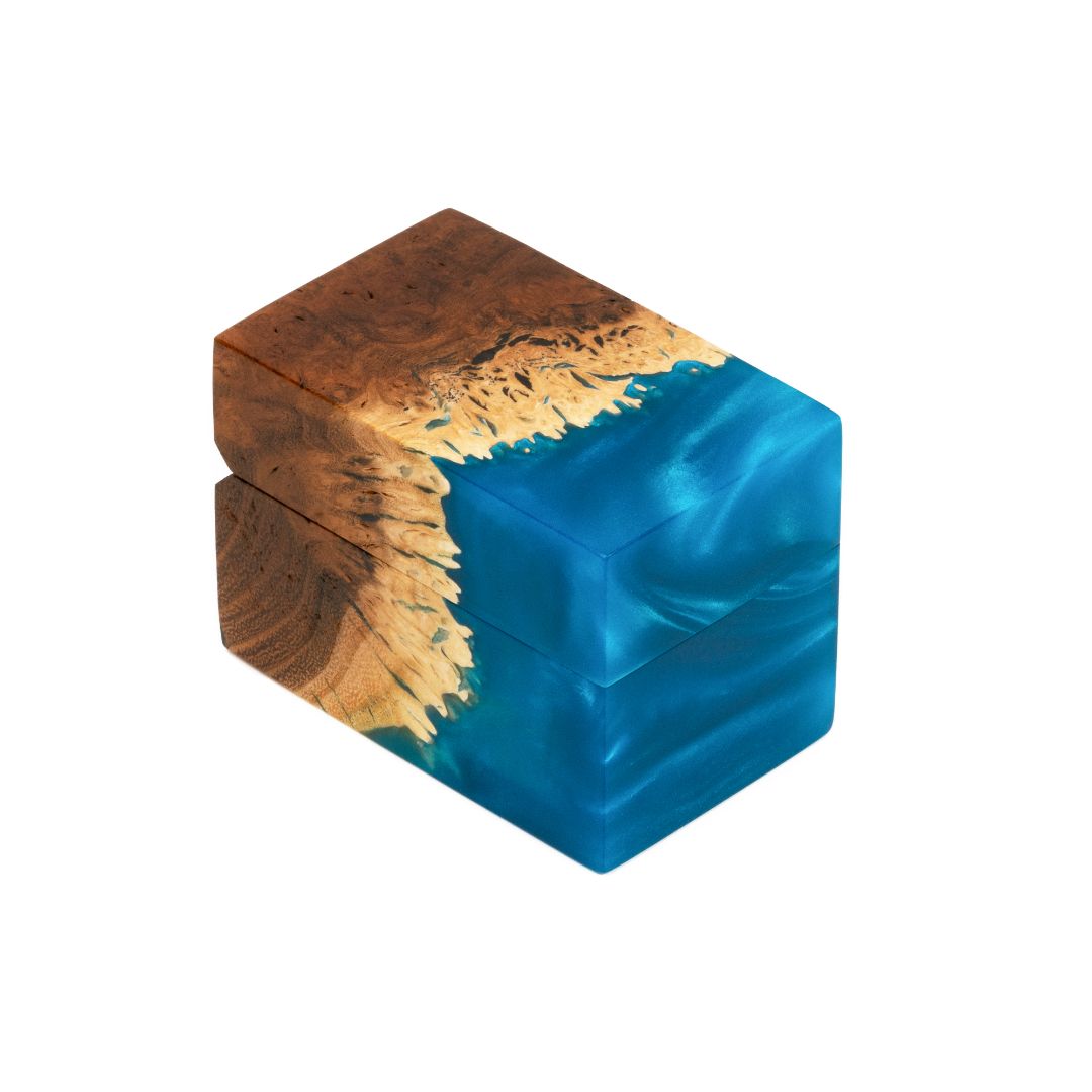 Handcrafted blue epoxy and elm wood engagement ring box photographed from a front angle