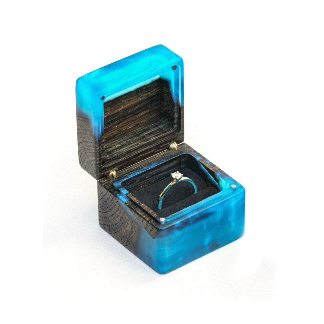 Premium open blue epoxy and bog oak wood engagement ring box photographed from the front