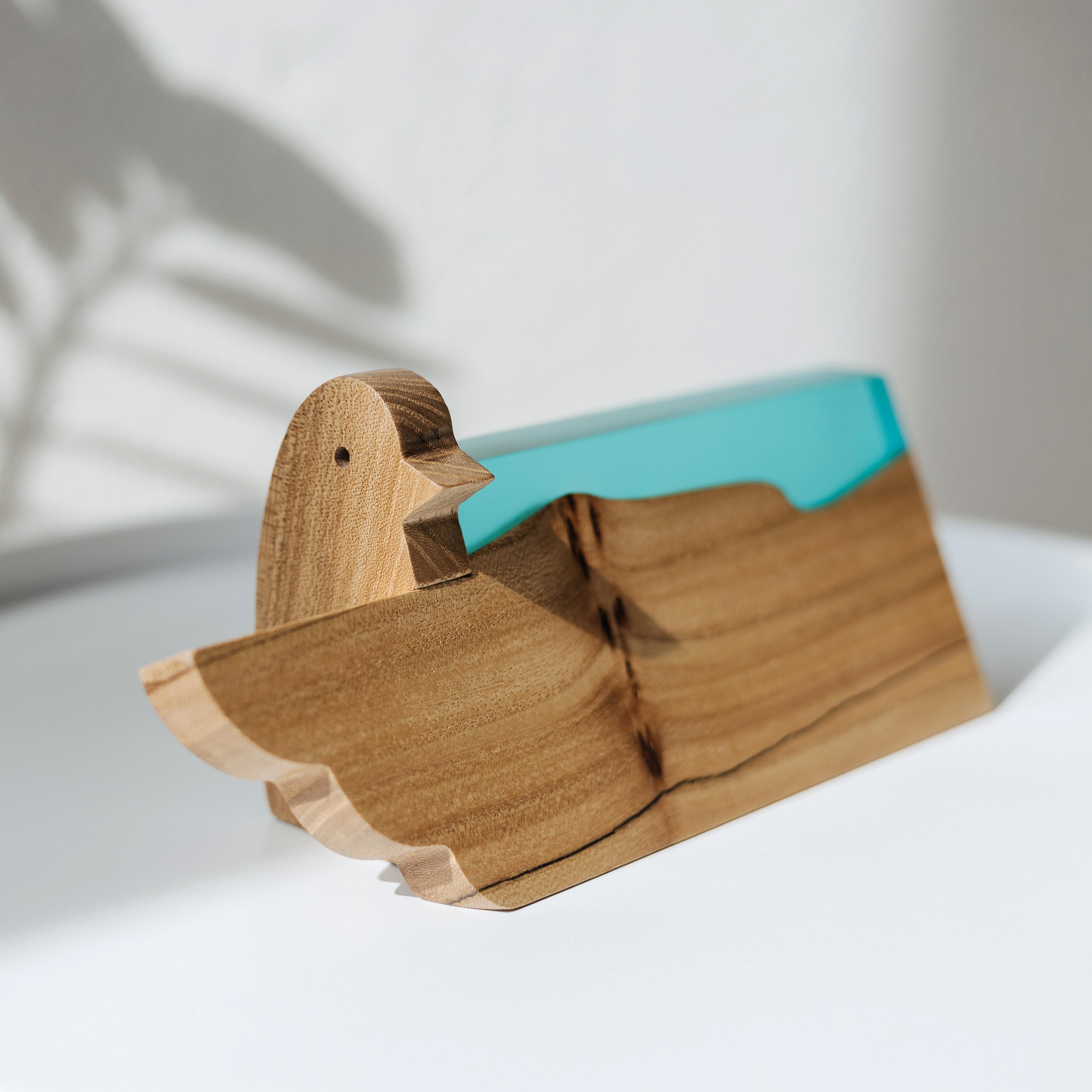 Angled view of the personalized BIRDY desk name plate handcrafted from elm wood and aqua blue epoxy resin