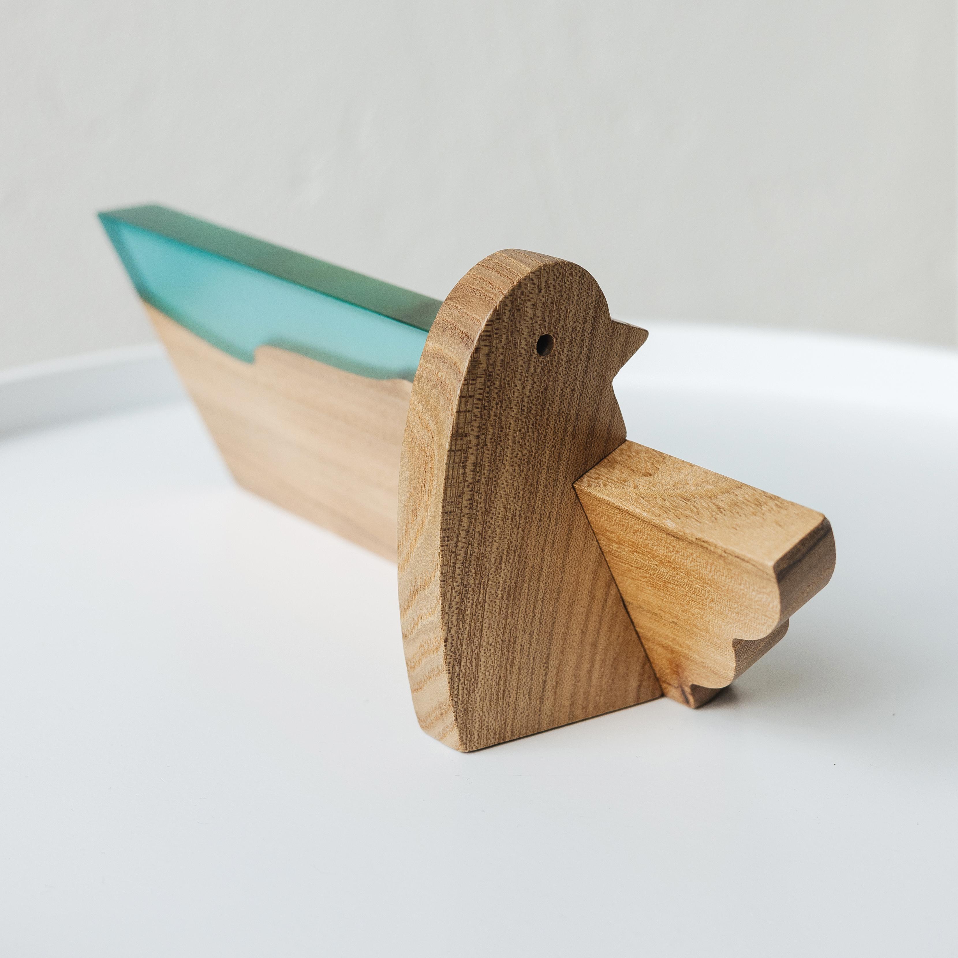 Perspective view of the personalized BIRDY desk name plate handcrafted from elm wood and aqua blue epoxy resin