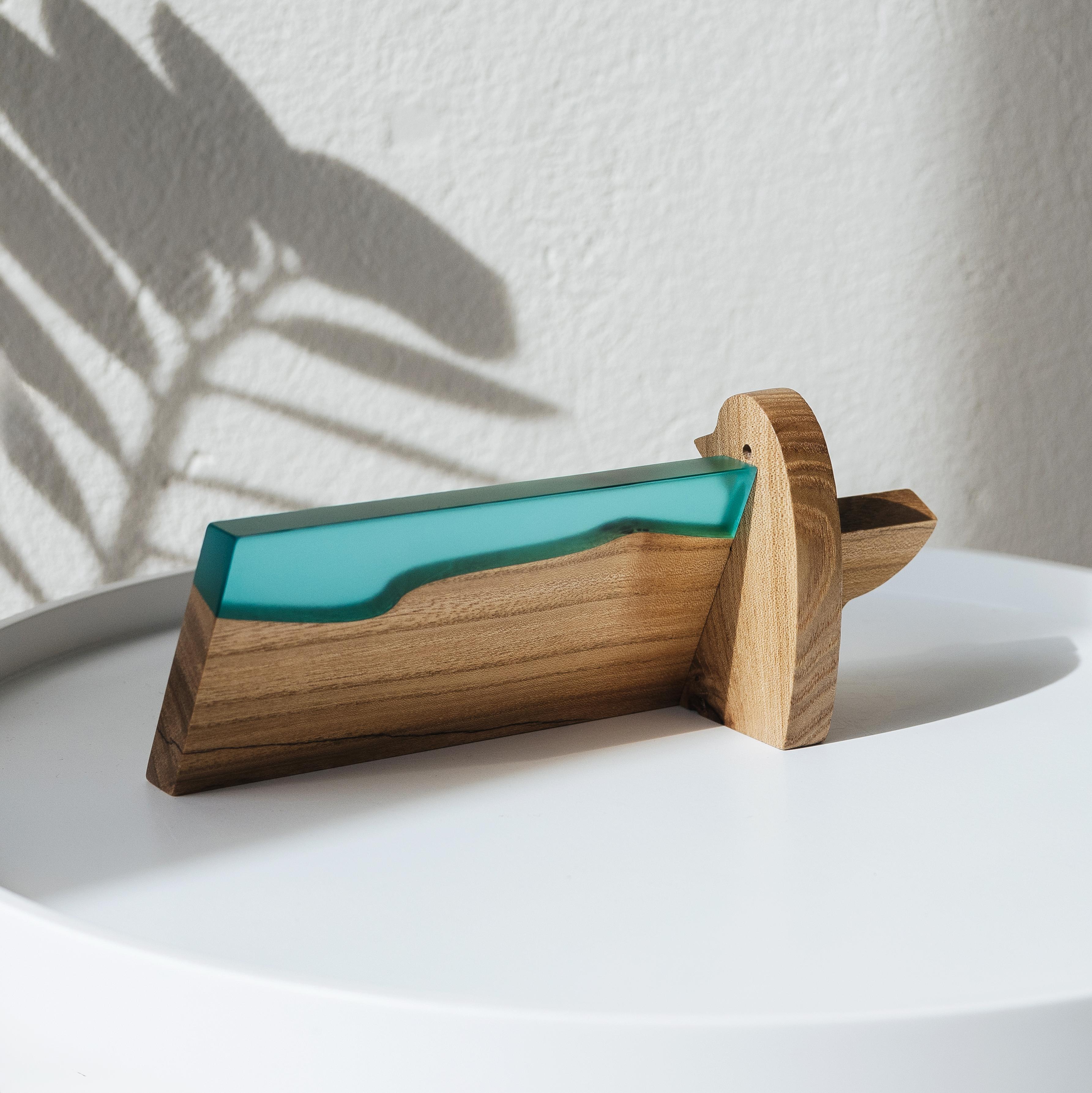 Side view of the personalized BIRDY desk name plate made from elm wood and aqua blue epoxy resin