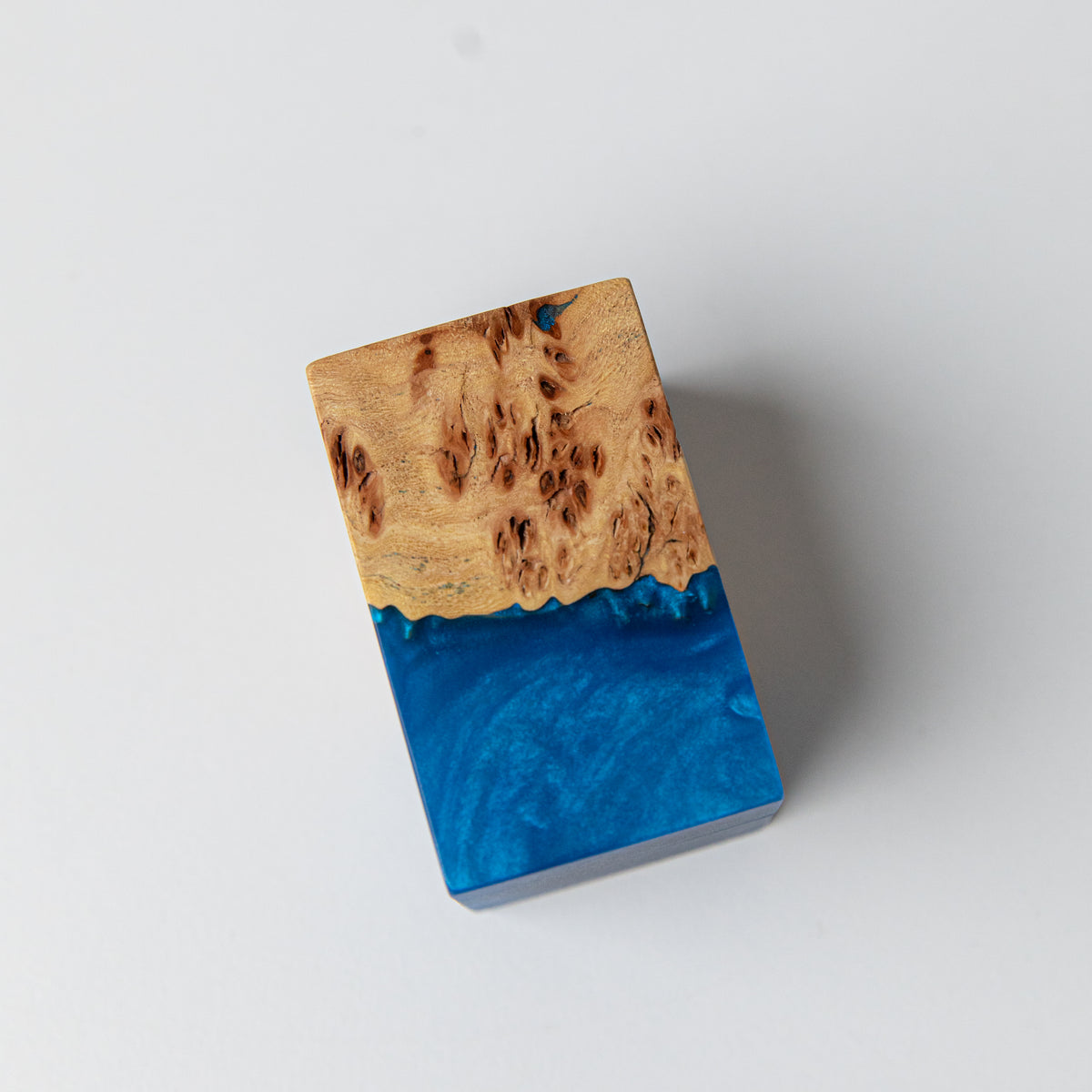 Top of the closed blue ring box, where elm burl meets swirling blue epoxy resin