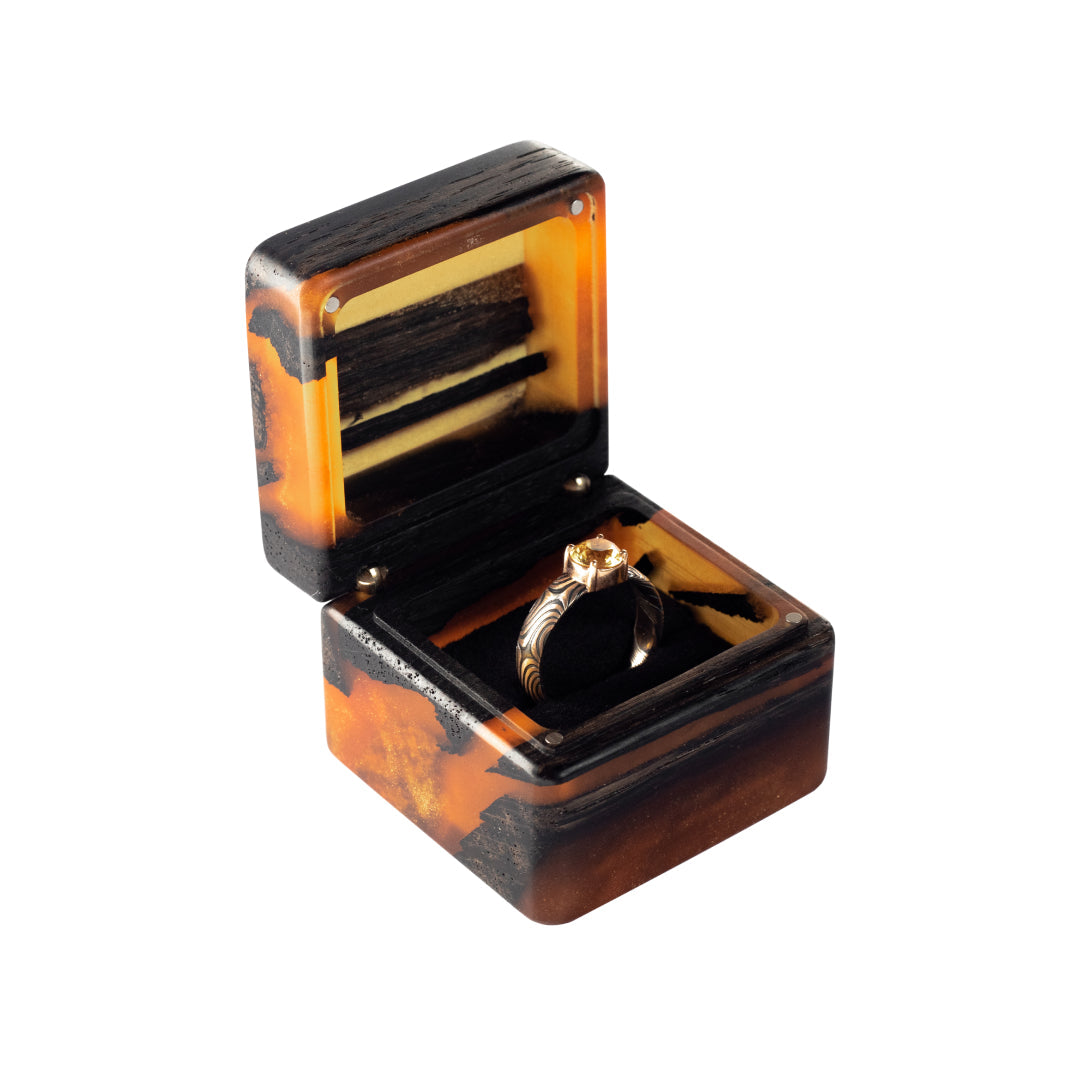 Front view of the open amber epoxy and bog oak wood proposal ring box with black ring holder