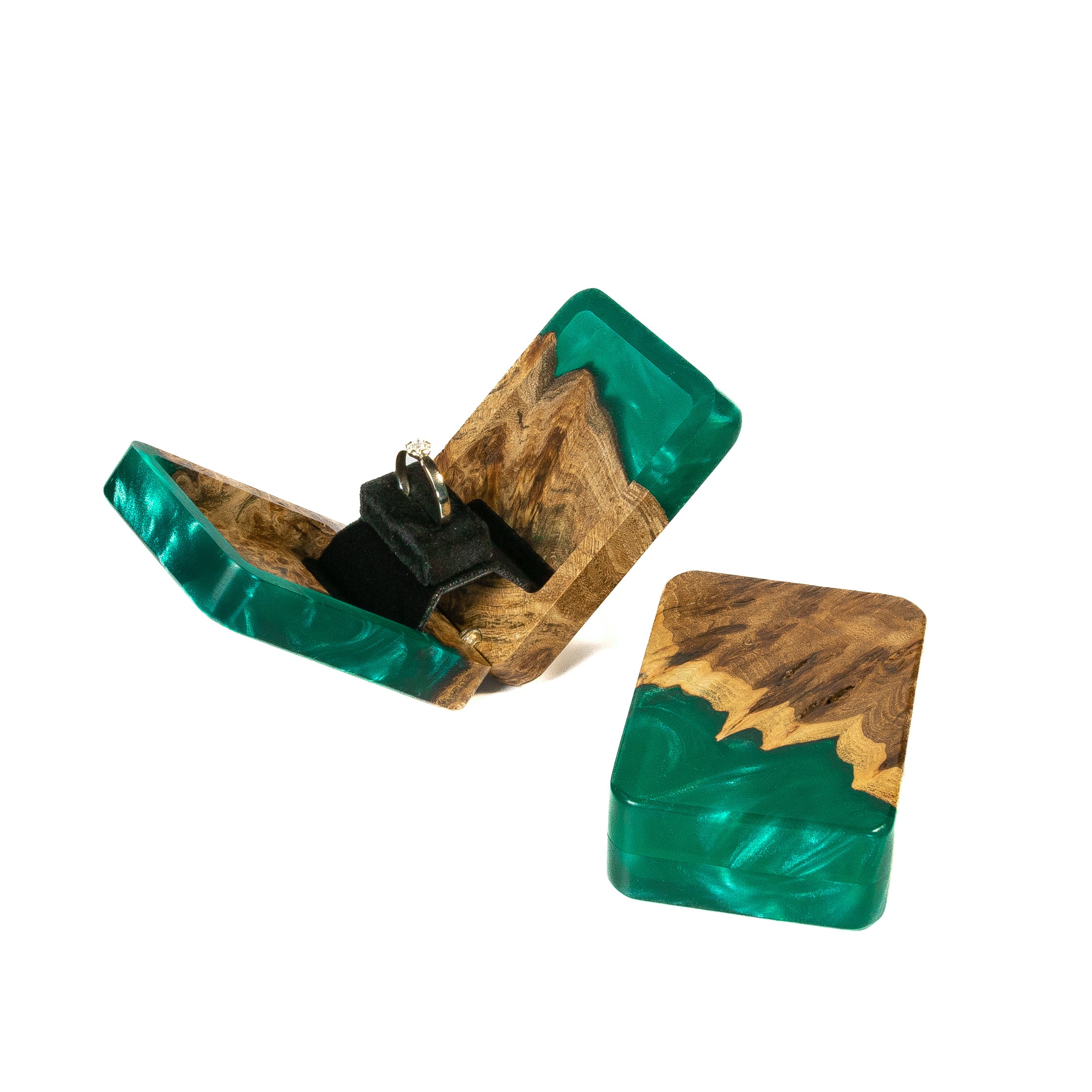 Handcrafted green epoxy and elm wood engagement ring box photographed from an angled perspective