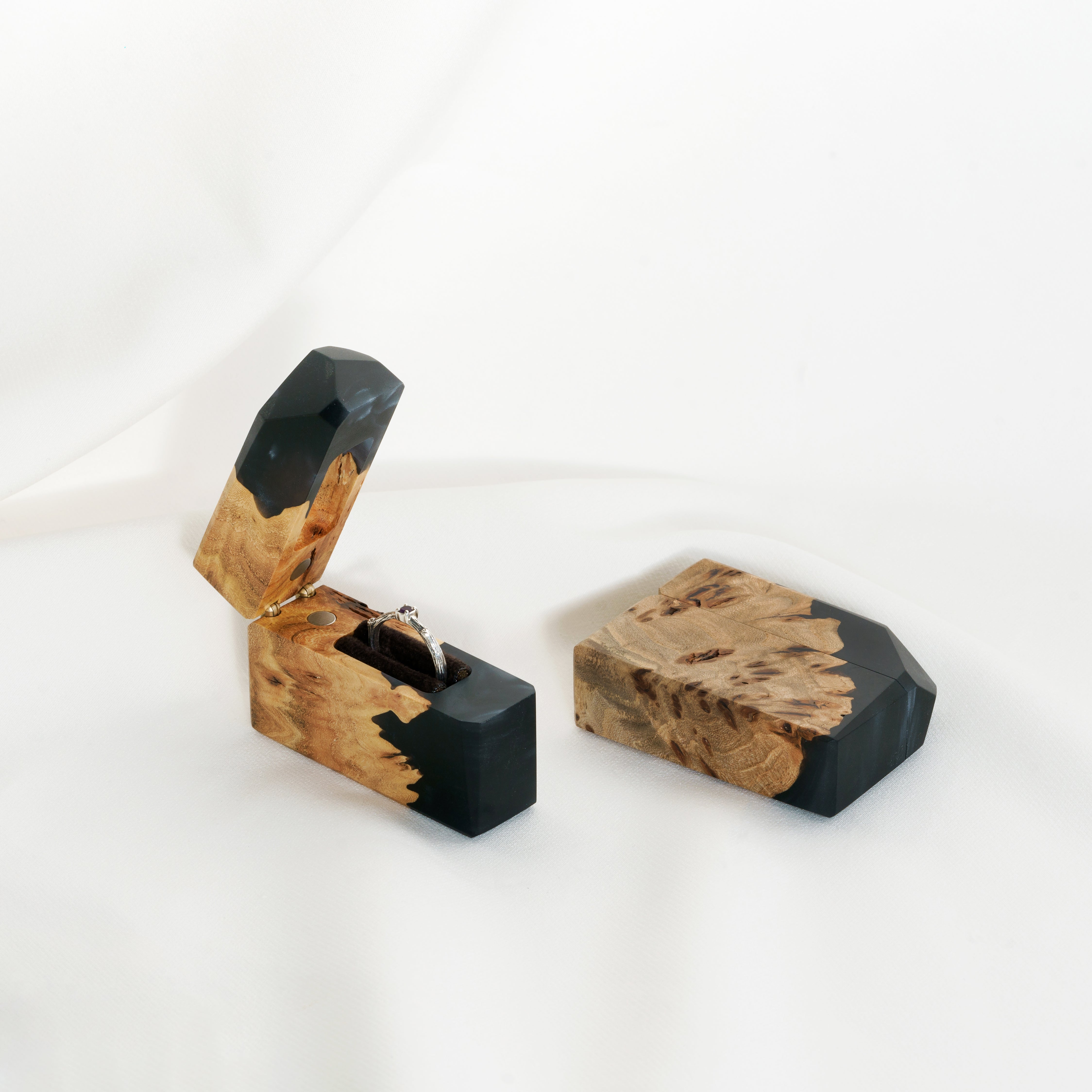 Luxury black epoxy and elm wood engagement ring box displayed open with the lid beside it