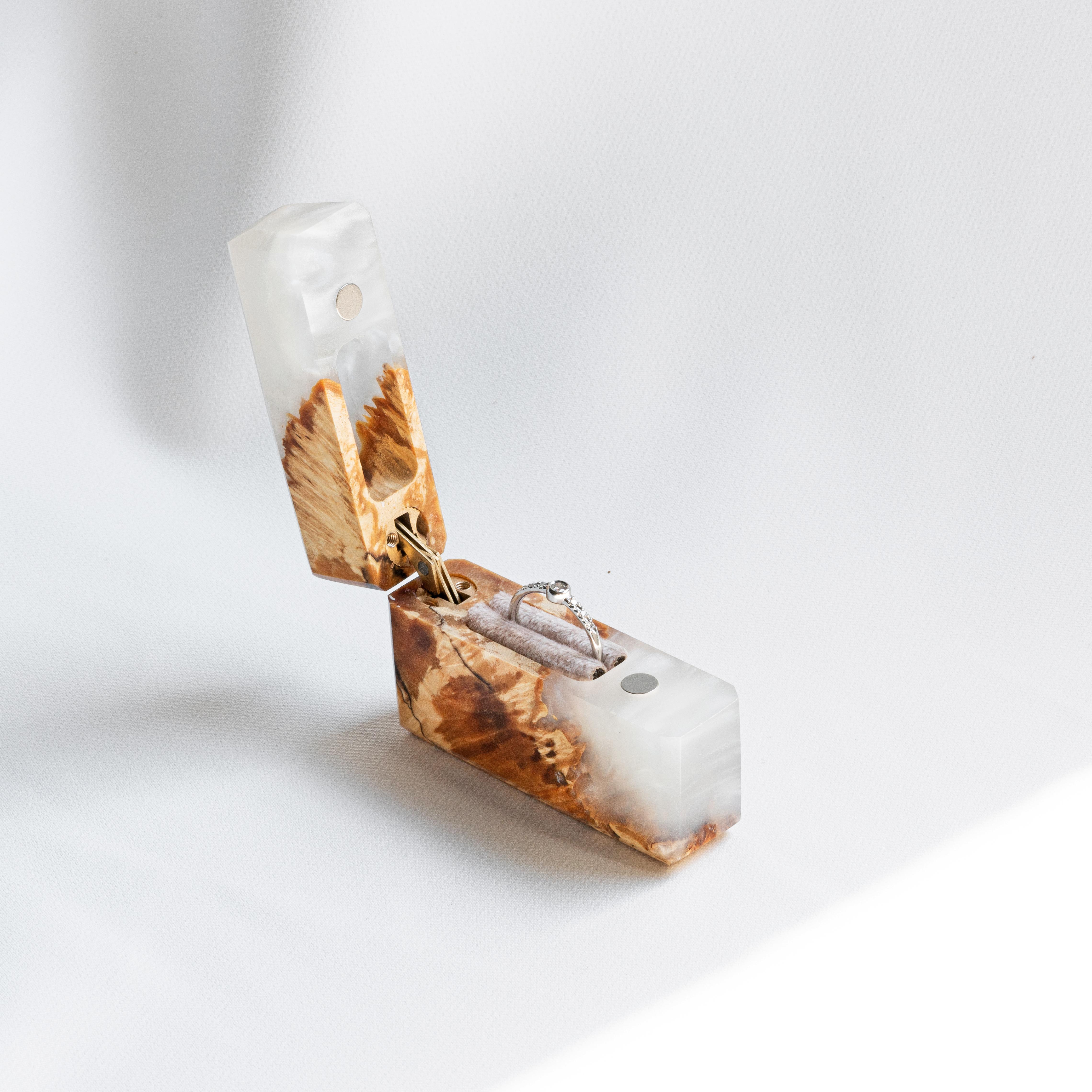 Luxury platinum epoxy and maple wood engagement ring box displayed open on a white background
