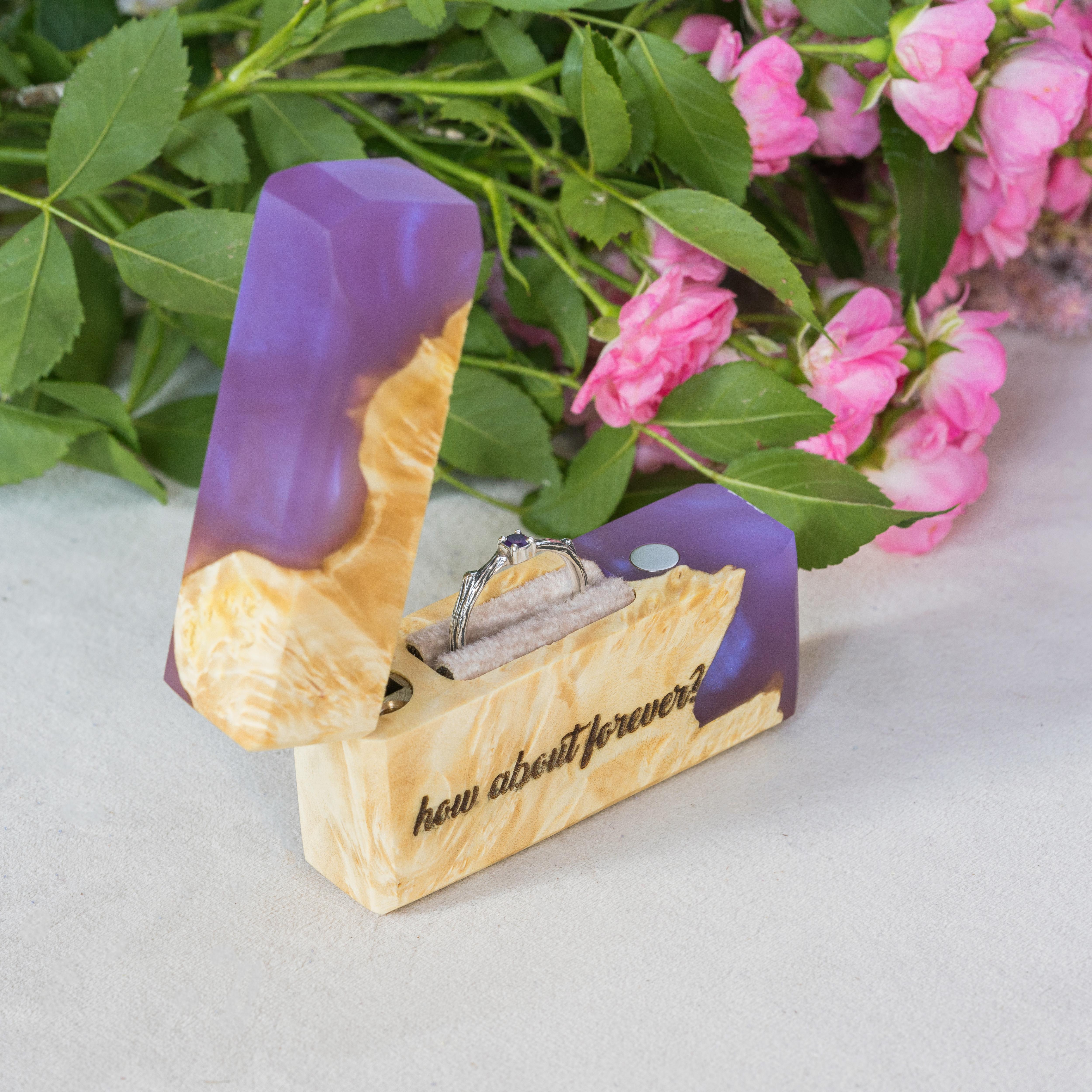 Luxury purple epoxy and maple wood engagement ring box displayed with pink flowers
