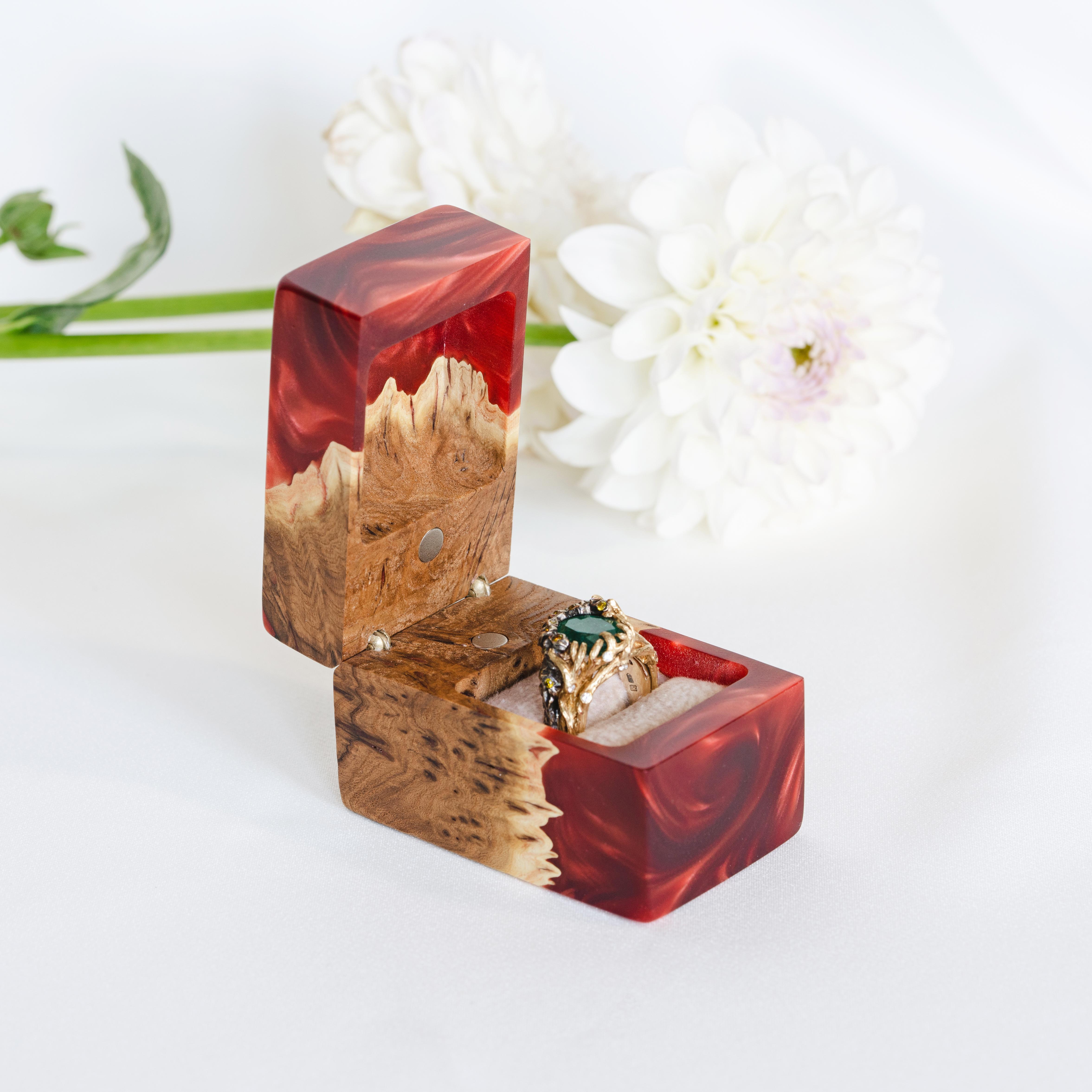 Ruby epoxy and elm wood engagement ring box displayed open with white floral accents