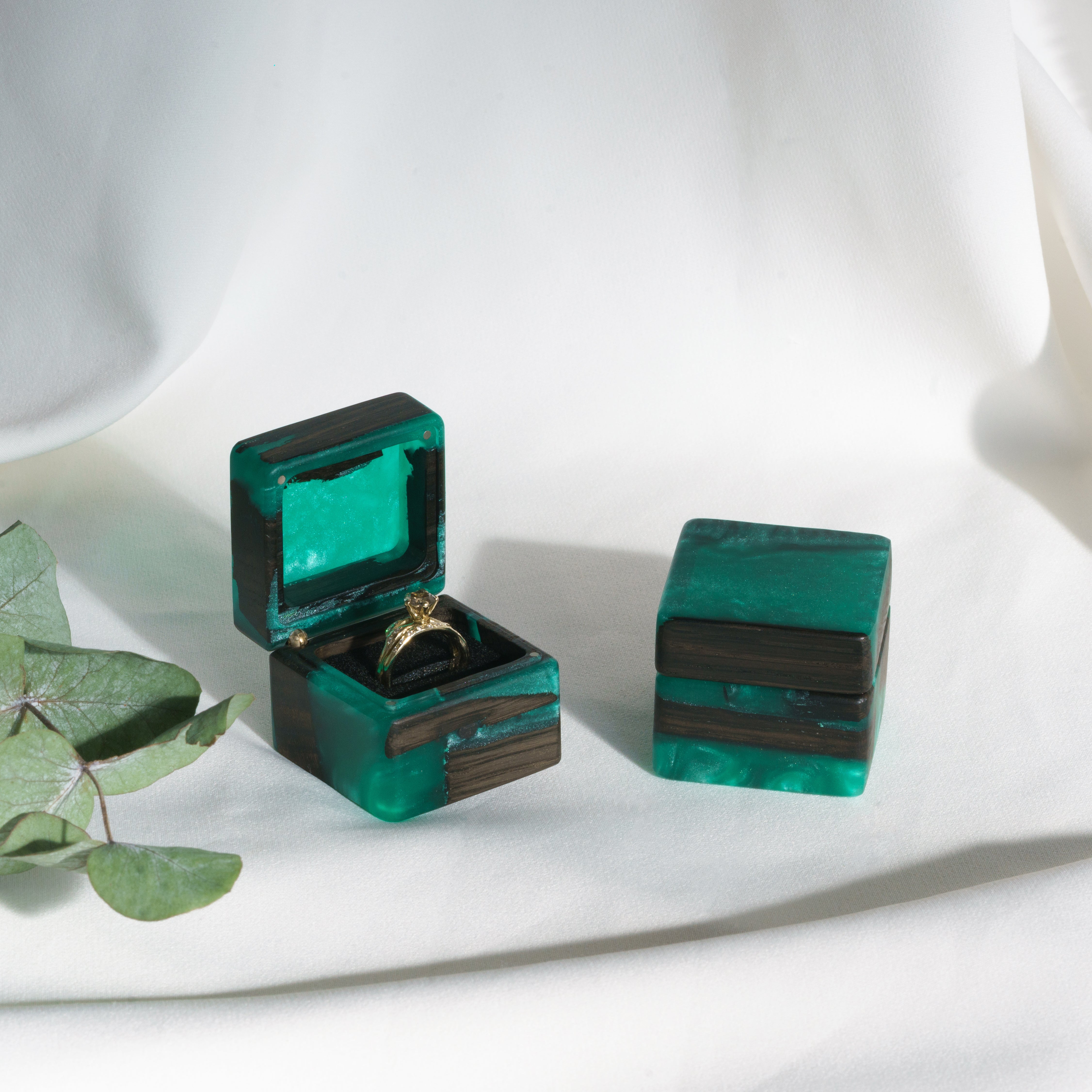 Three green epoxy and bog oak wood engagement ring boxes displayed together, MUSE collection
