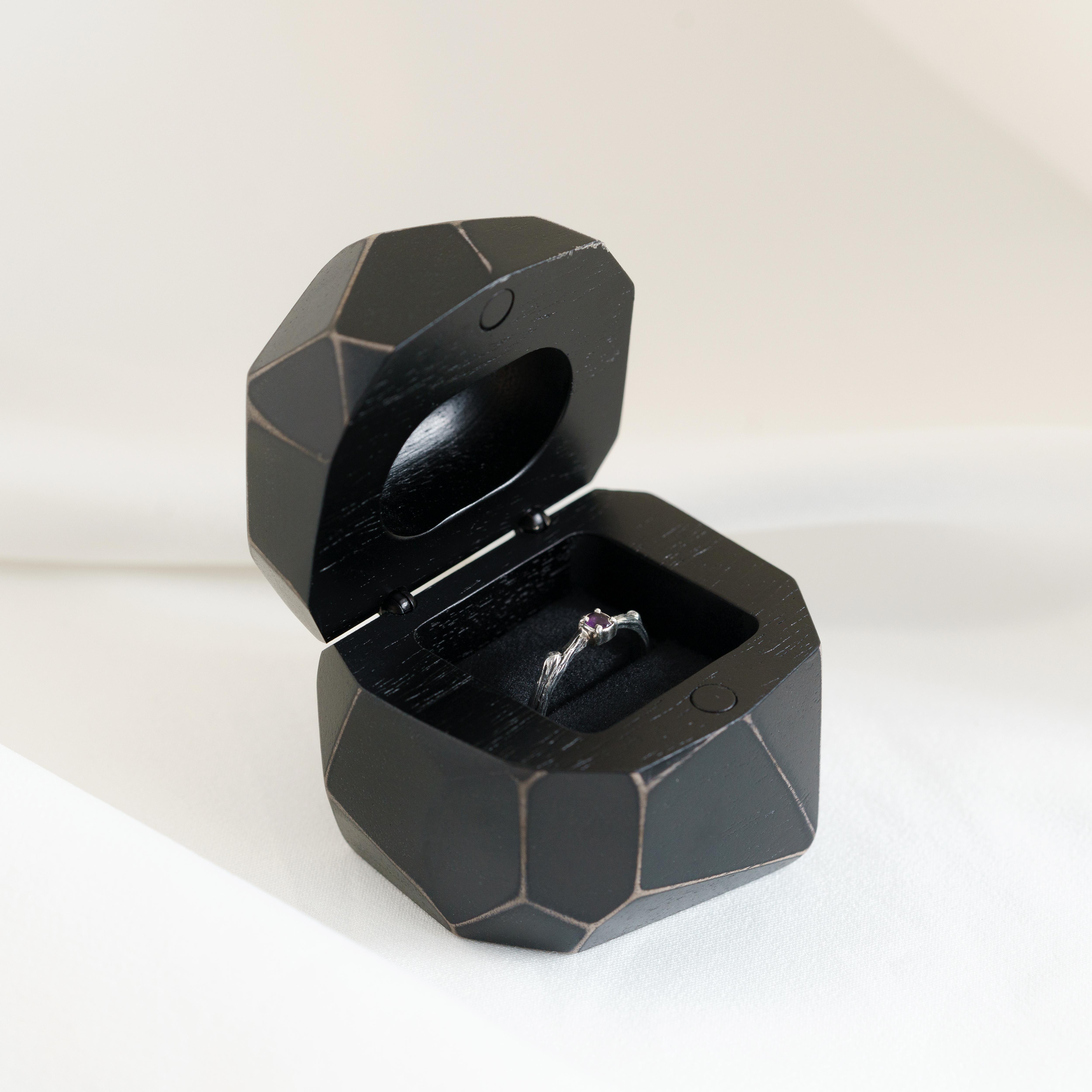 Luxury black epoxy and bog oak wood proposal ring box displayed open on a white background