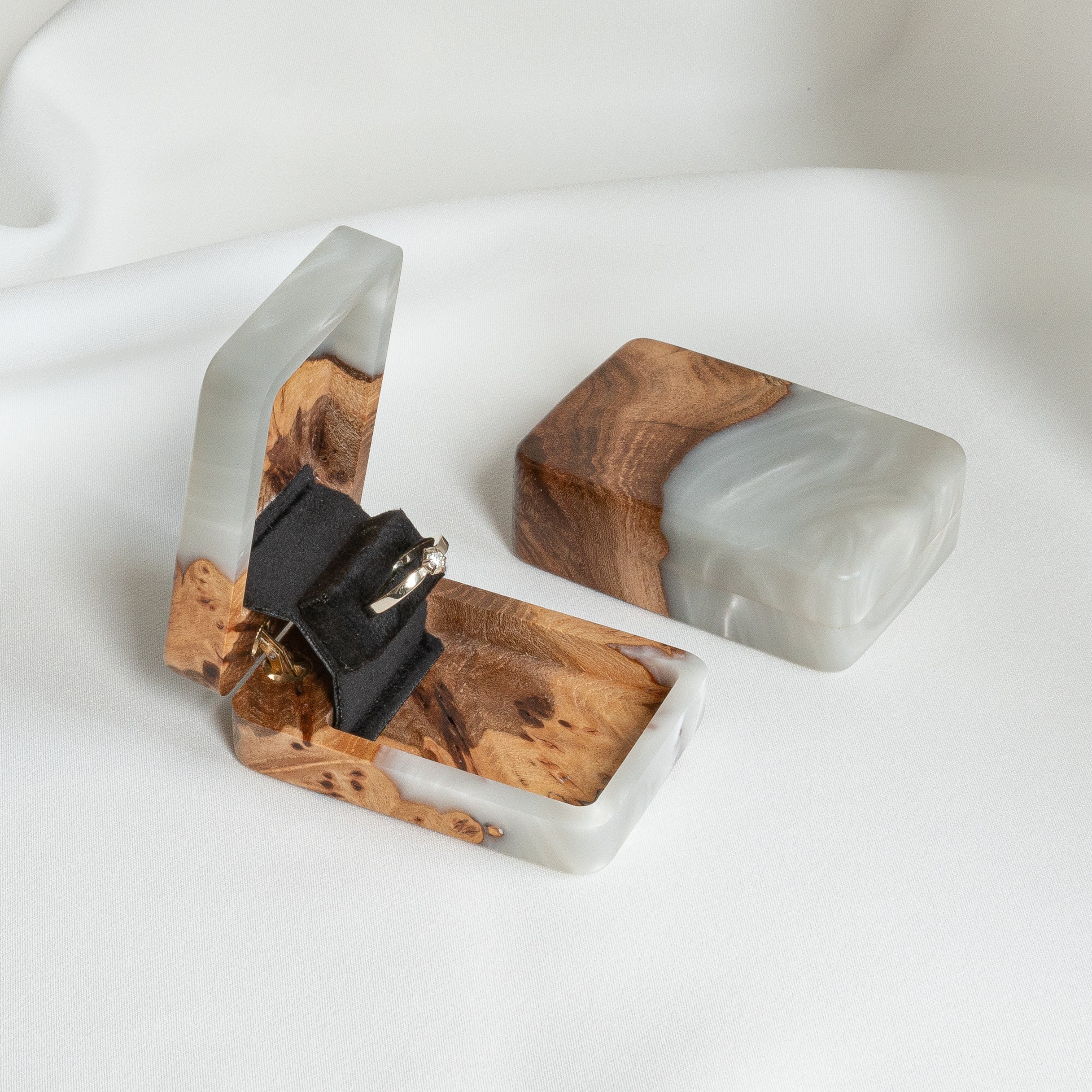 Luxury platinum epoxy and elm wood proposal ring box displayed open with the lid beside it