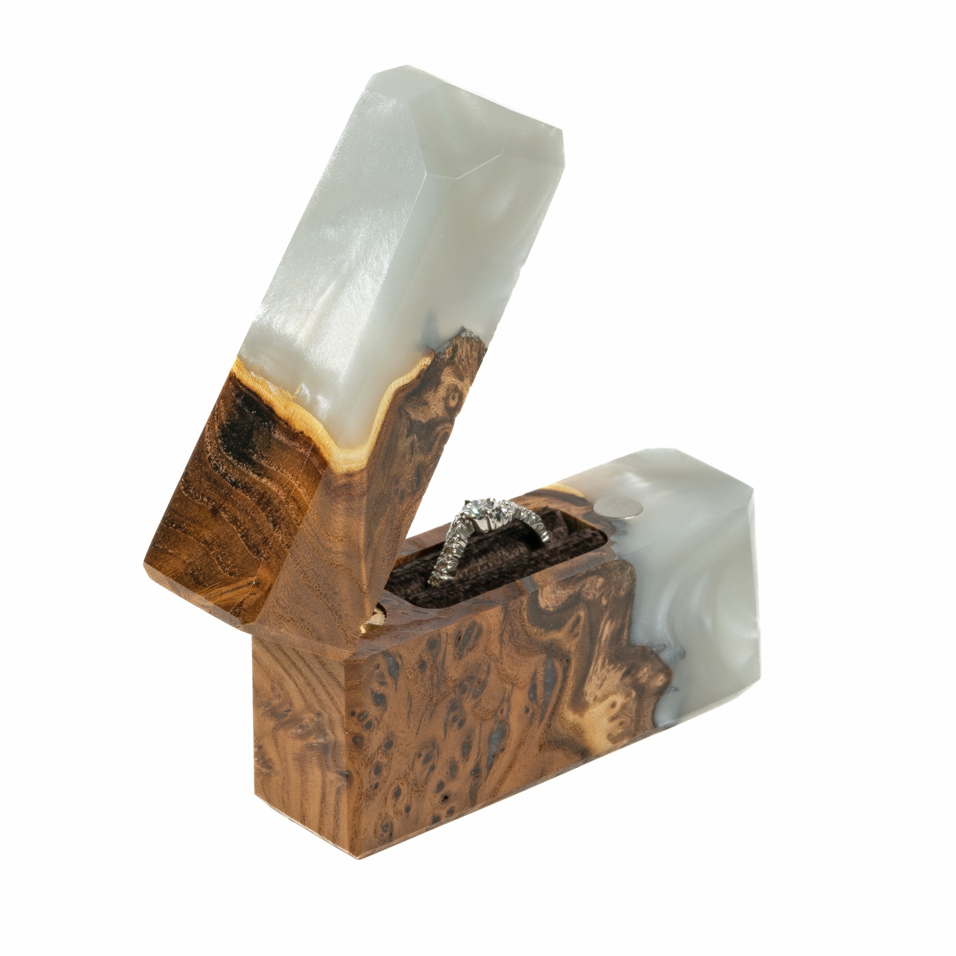 Modern platinum epoxy and elm wood engagement ring box displayed in a minimalist studio setting