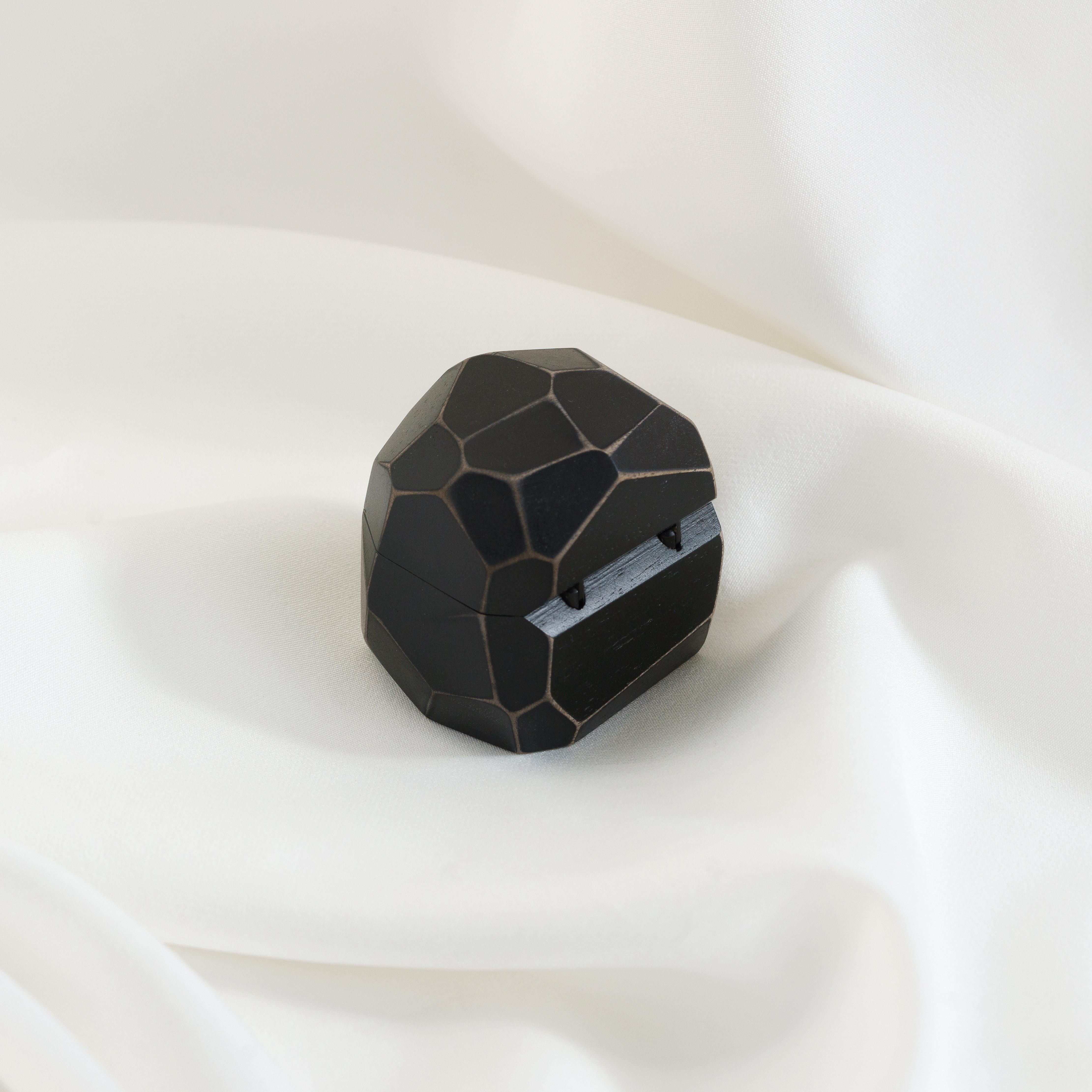 Modern black epoxy and bog oak wood proposal ring box photographed from the front