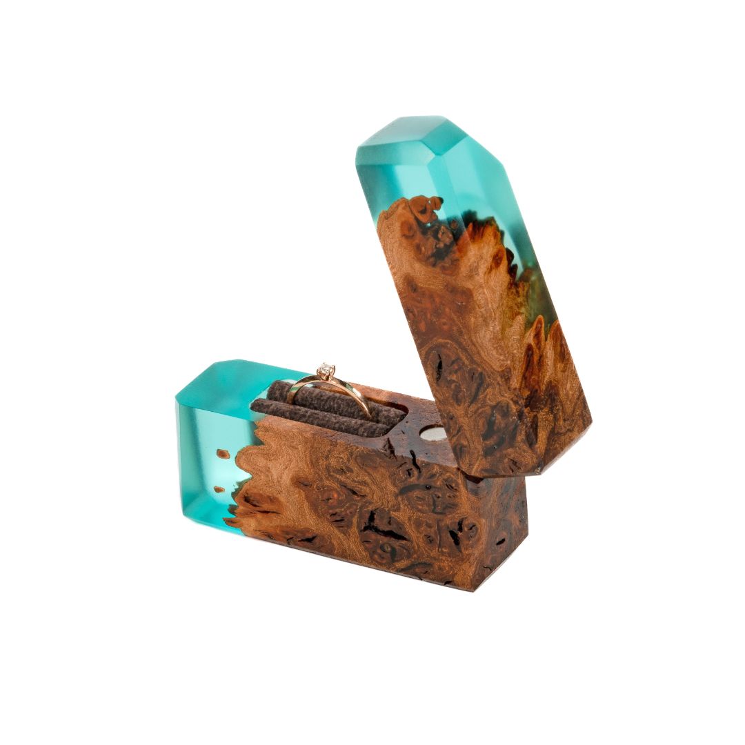 Close-up of the natural maple wood grain and aqua blue epoxy on the FLASH engagement ring box
