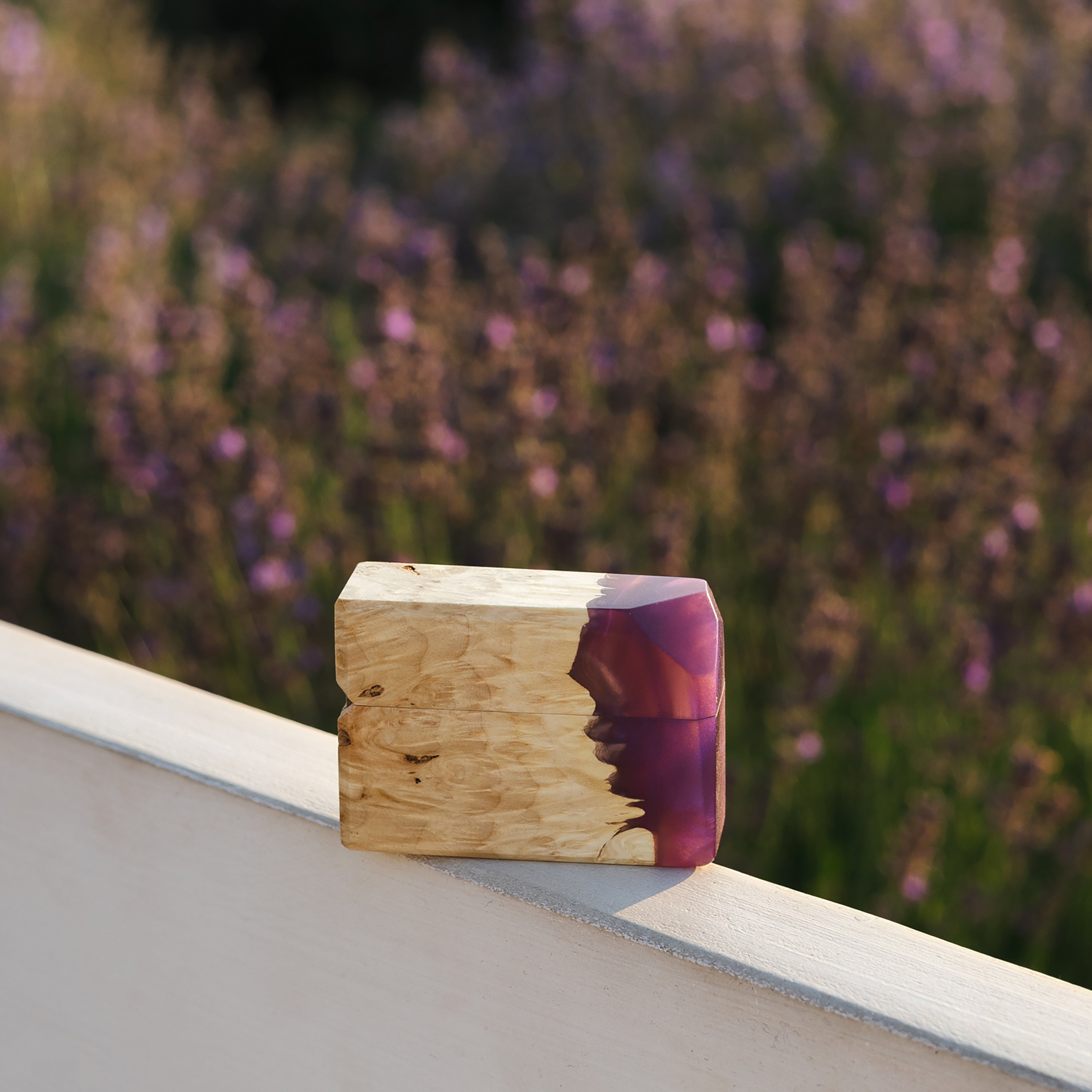 Purple epoxy and maple wood engagement ring box showcased against a natural outdoor background