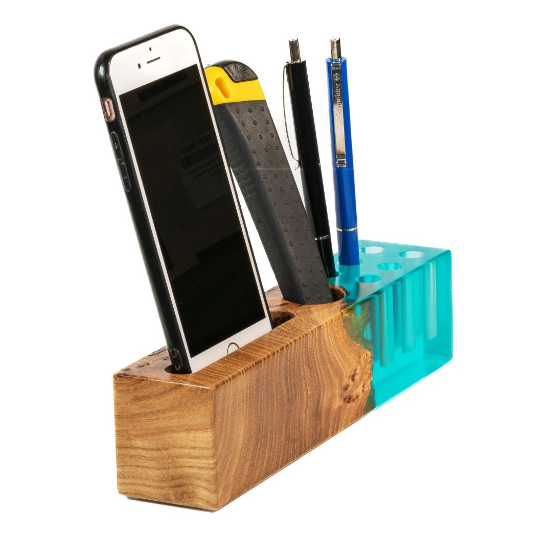 Angled view of the ELEMENT office desk organizer with phone stand and pen holder made from elm wood and aqua blue epoxy resin