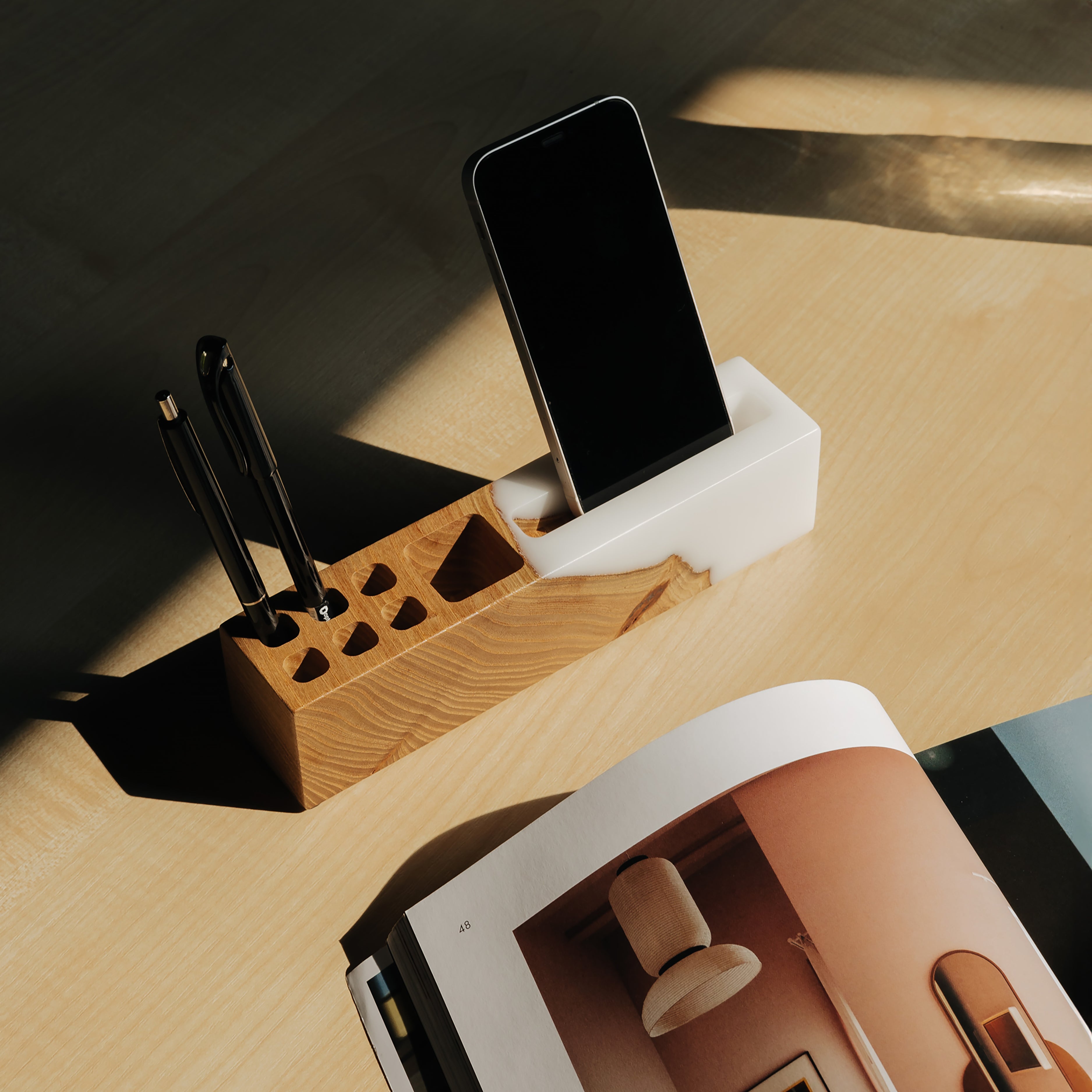 Front view of the ELEMENT office desk organizer with phone stand and pen holder made from elm wood and white epoxy resin