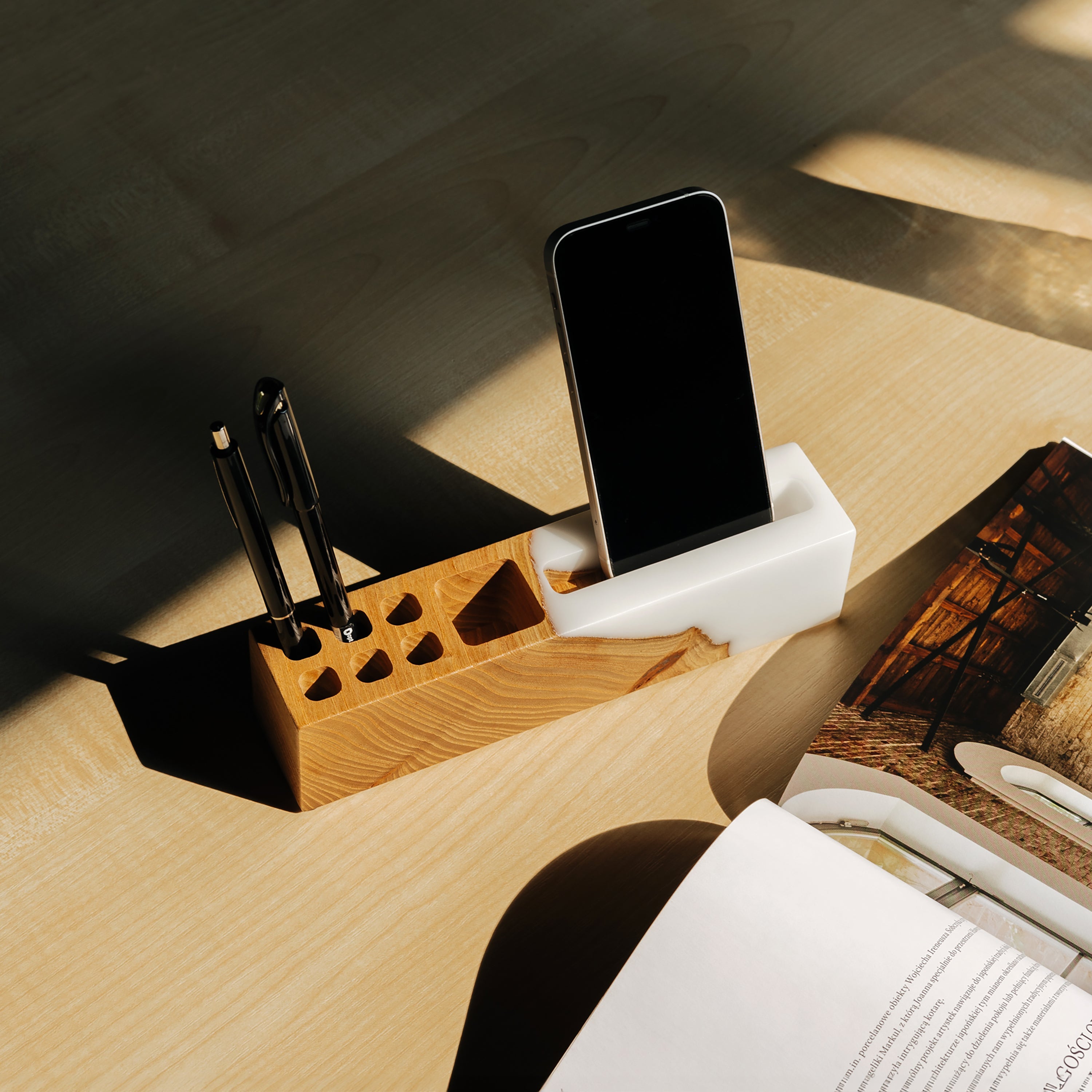 Lifestyle view of the ELEMENT office desk organizer displayed on a modern office desk, handcrafted from elm wood and white epoxy resin
