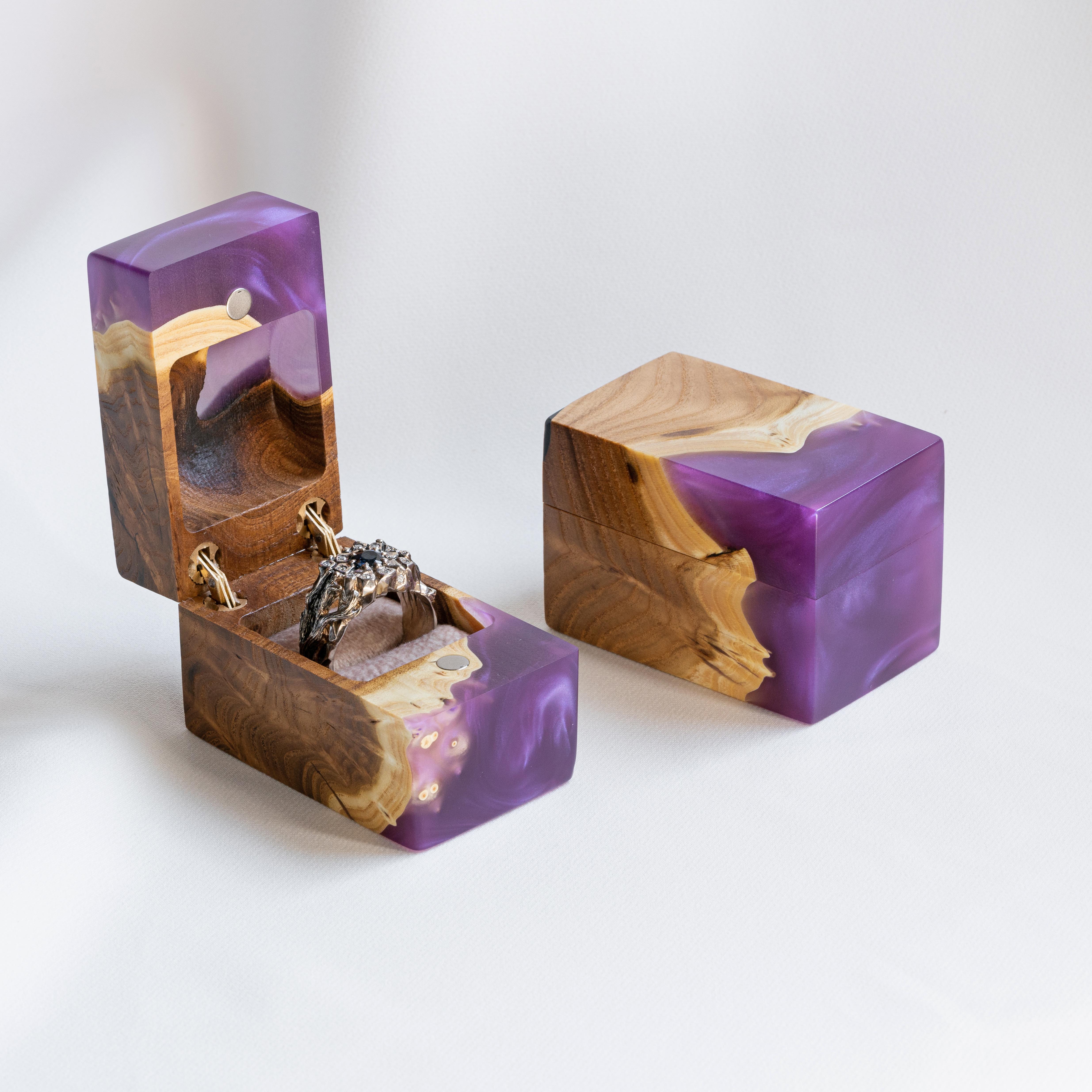 Open engagement ring box handcrafted from purple epoxy and elm wood with the matching closed box beside it