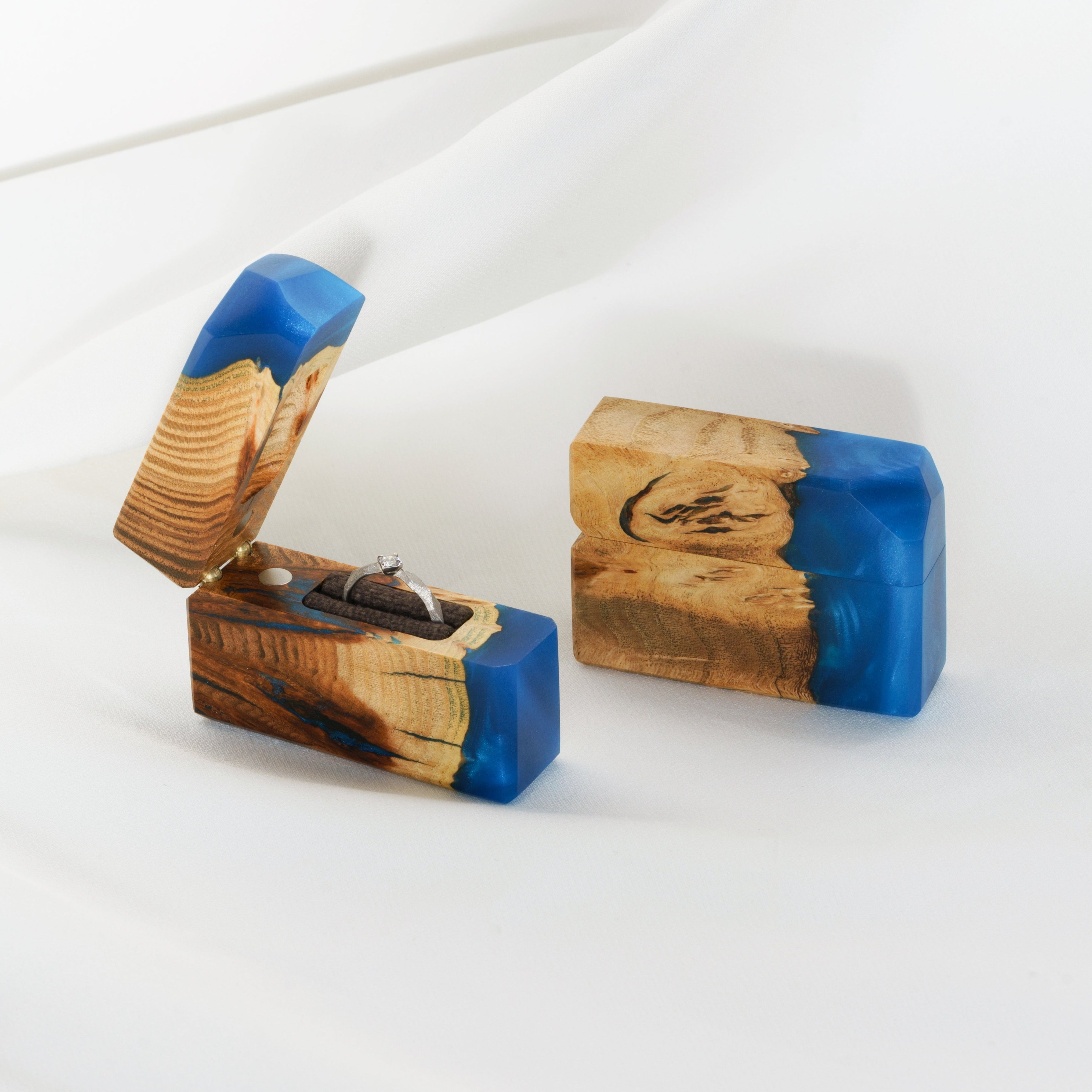 Open proposal ring box handcrafted from blue epoxy and elm wood with the matching closed box beside it