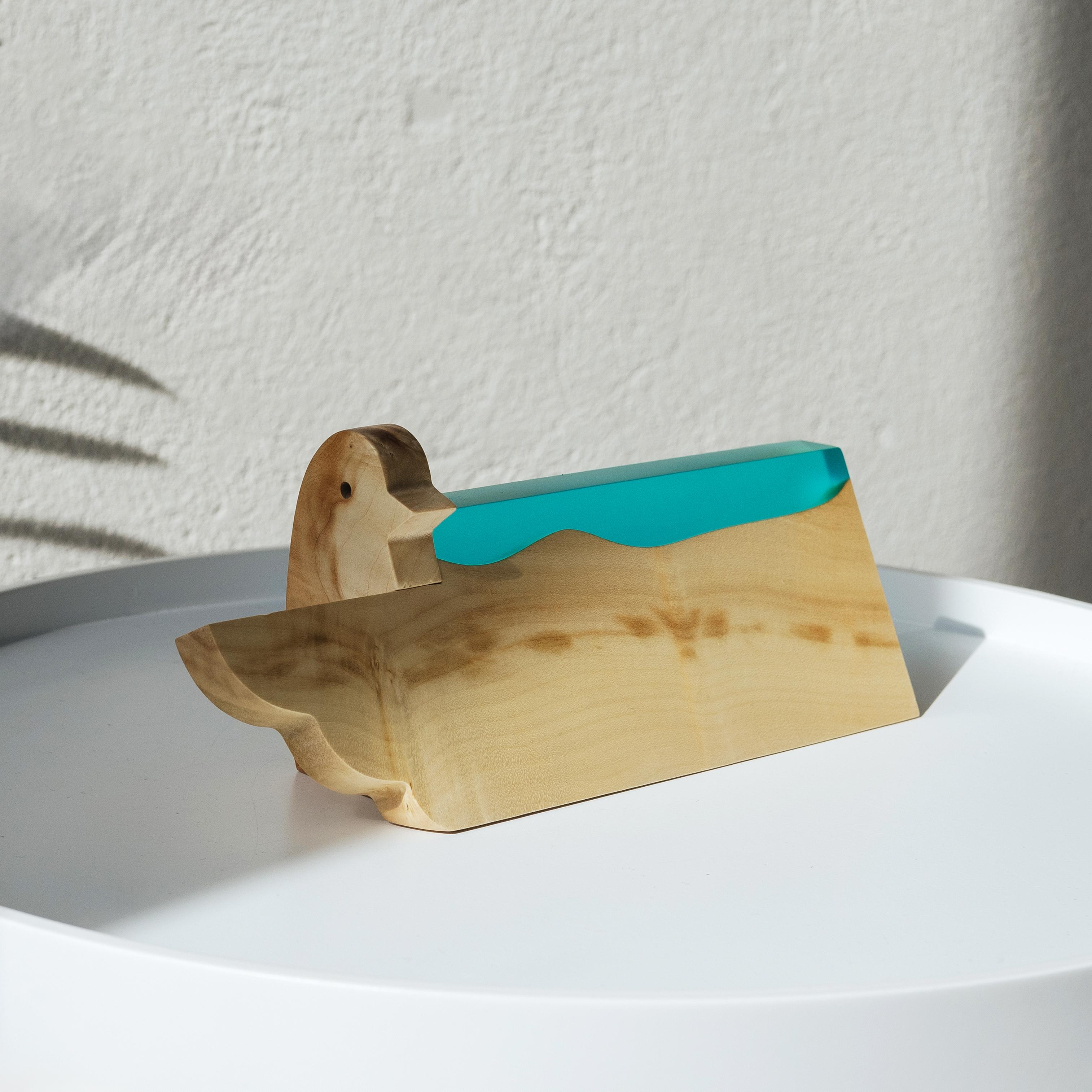 Angled view of the personalized BIRDY desk name plate handcrafted from maple wood and aqua blue epoxy resin