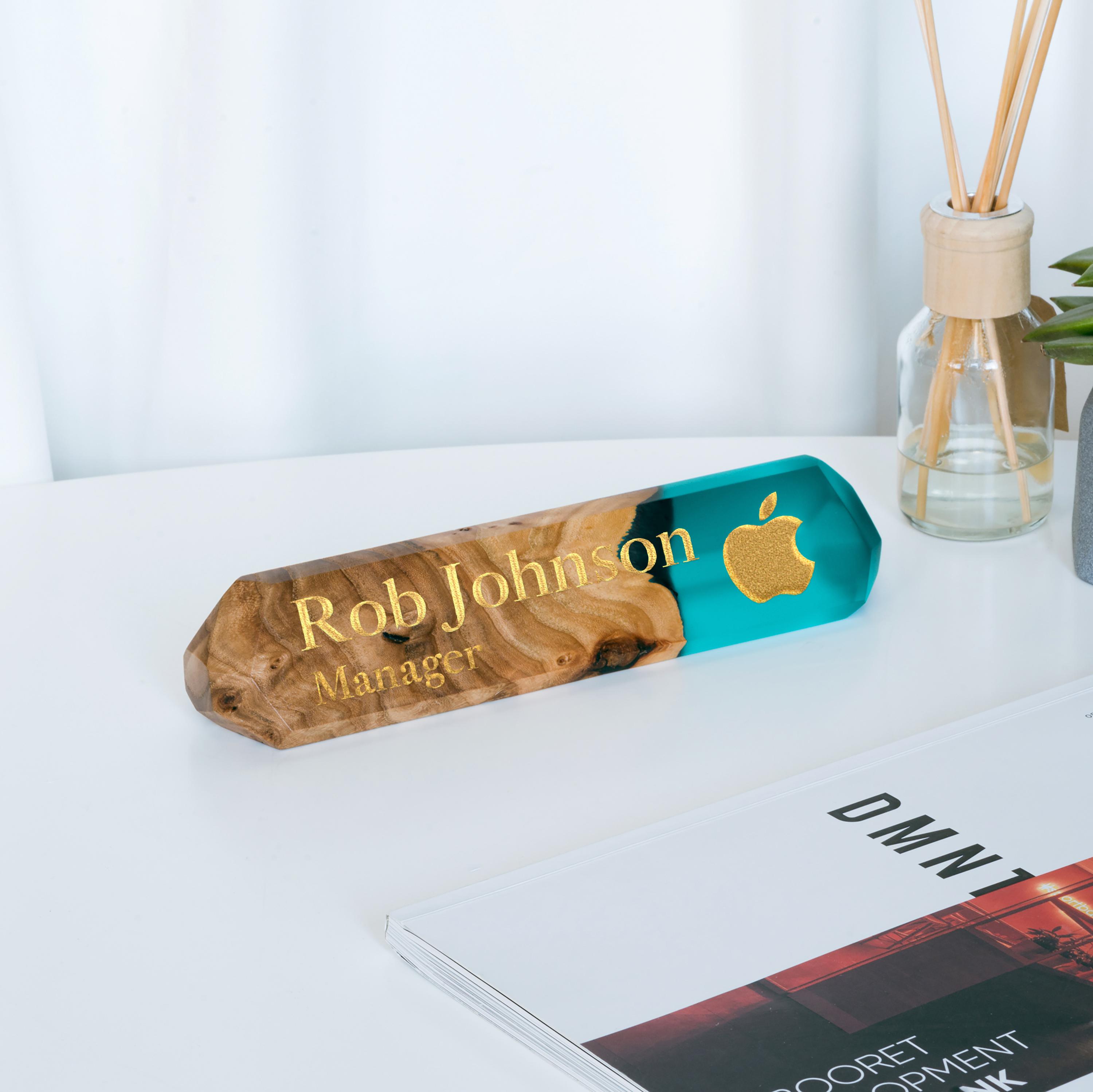 A name plaque with a wooden base and aqua blue resin name plate, with the text 'Rob Johnson - Manager'.