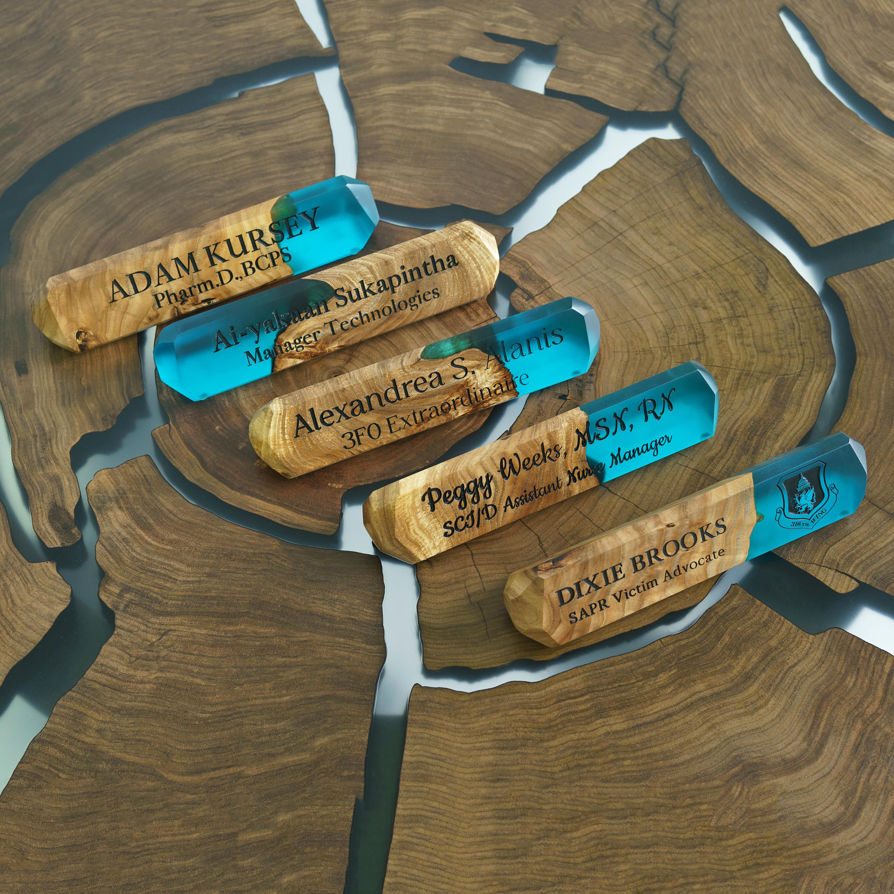 Collection of handcrafted personalized desk name plates made from elm wood and aqua blue epoxy resin