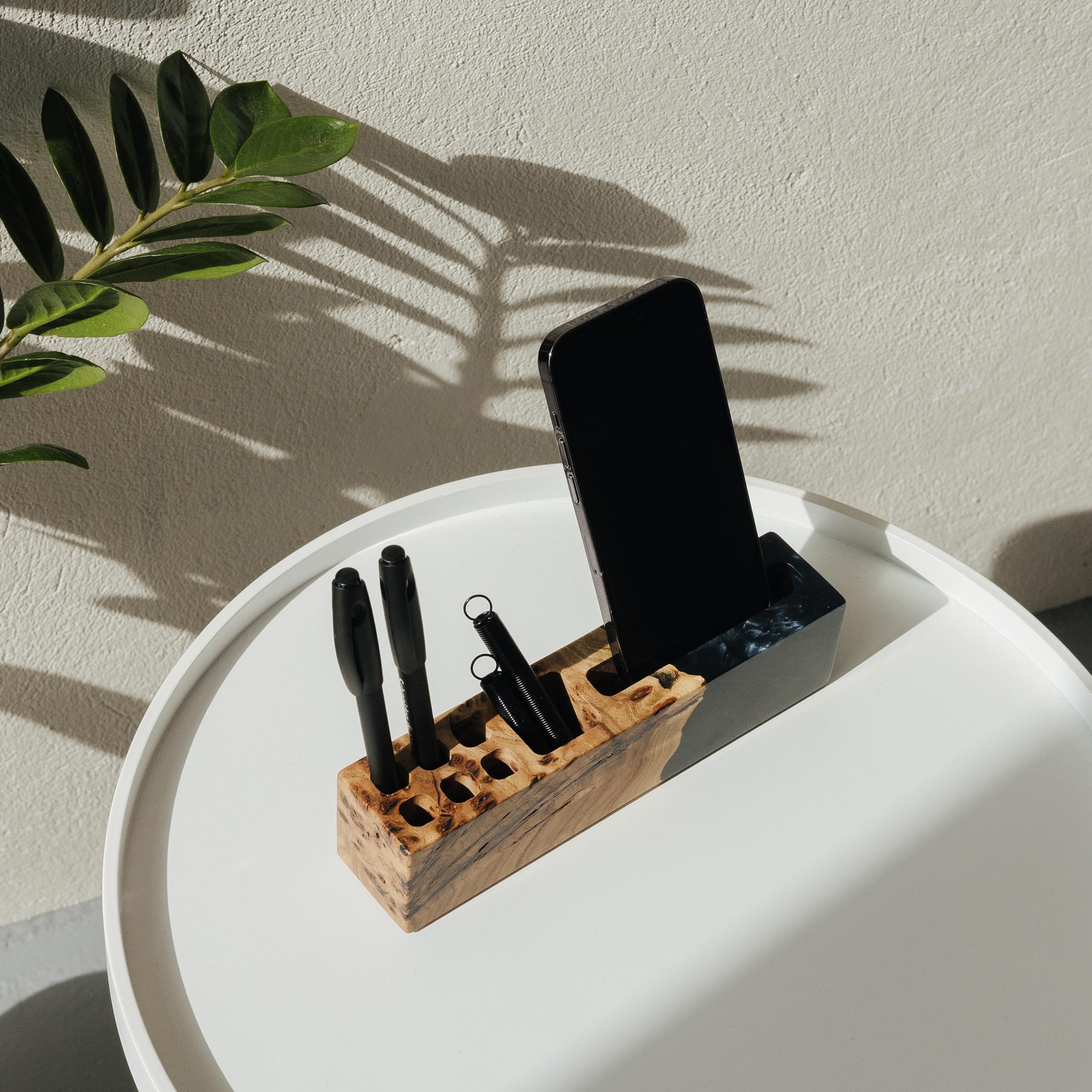 Front view of the ELEMENT wood desk organizer with phone stand and pen holder made from elm wood and black epoxy resin
