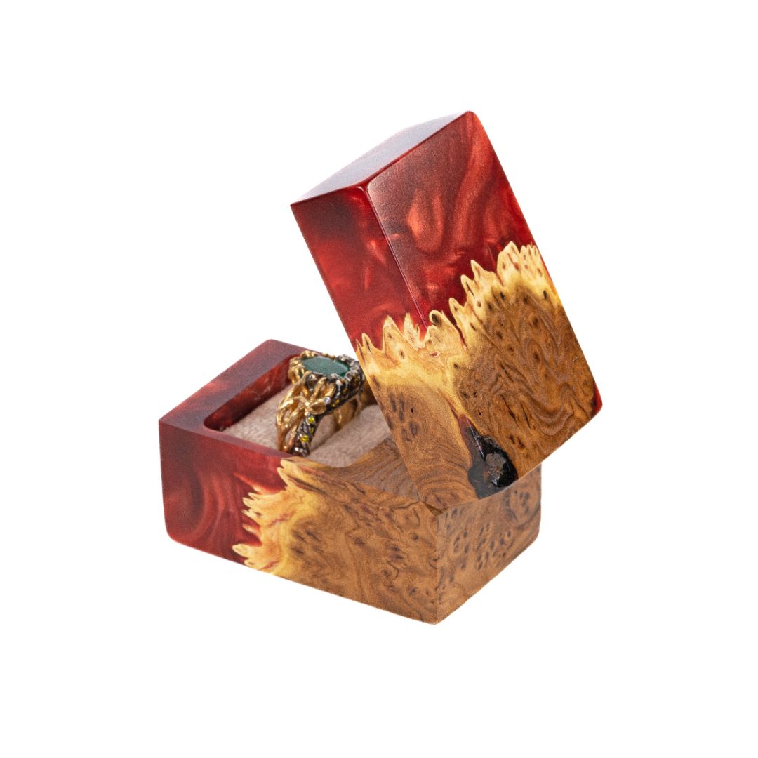 Angled view of the handcrafted ruby epoxy and elm wood engagement ring box with the lid open