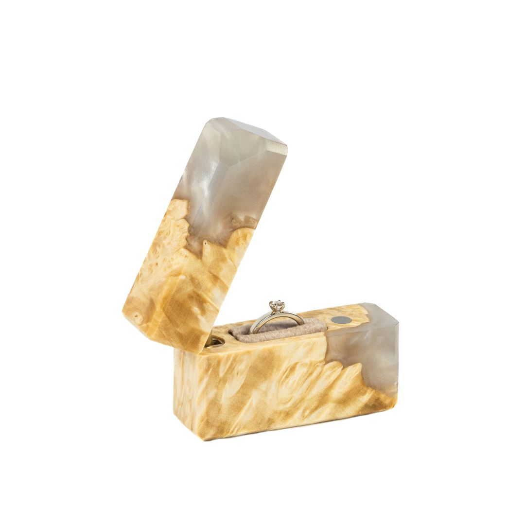 Elegant platinum epoxy and maple wood engagement ring box photographed from the side with the lid open