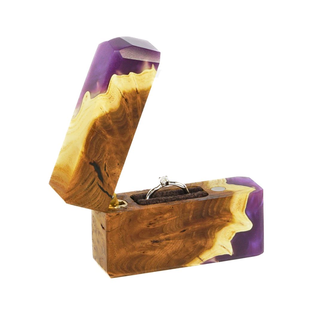 Elegant open purple epoxy and elm wood proposal ring box displayed on a white background