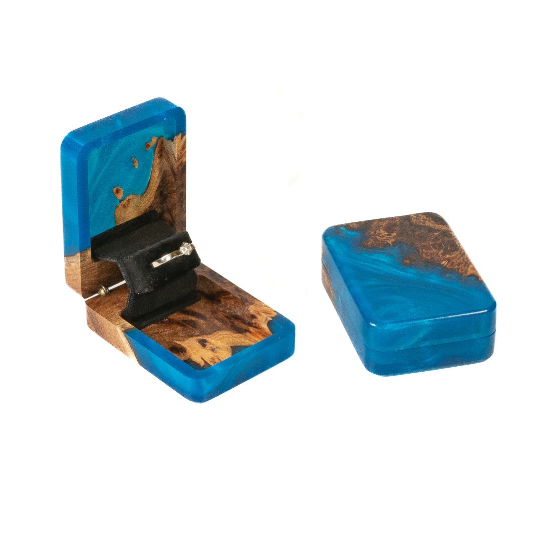 Open and closed blue epoxy and elm wood proposal ring box displayed together