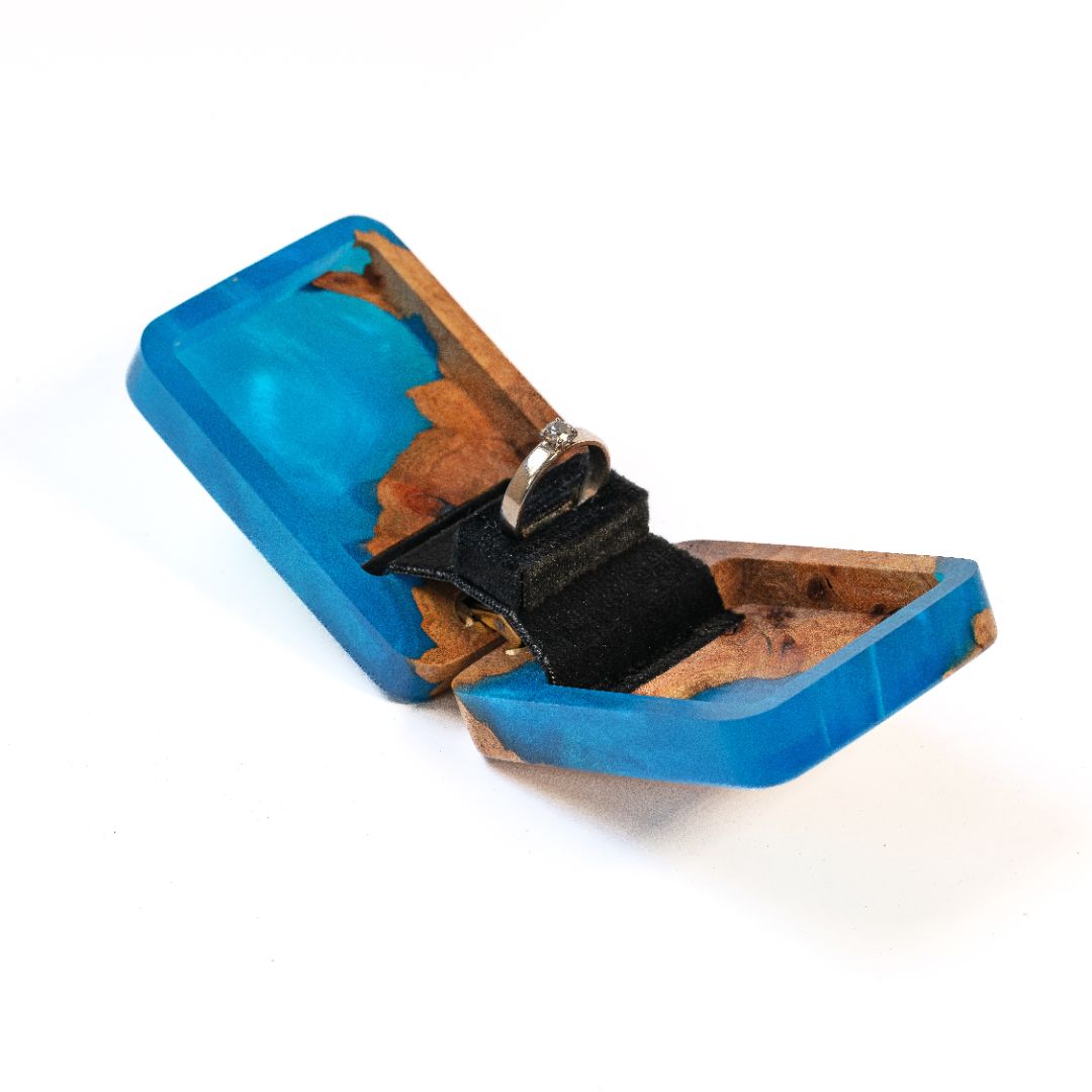 Modern blue epoxy and elm wood proposal ring box shown from an angled perspective