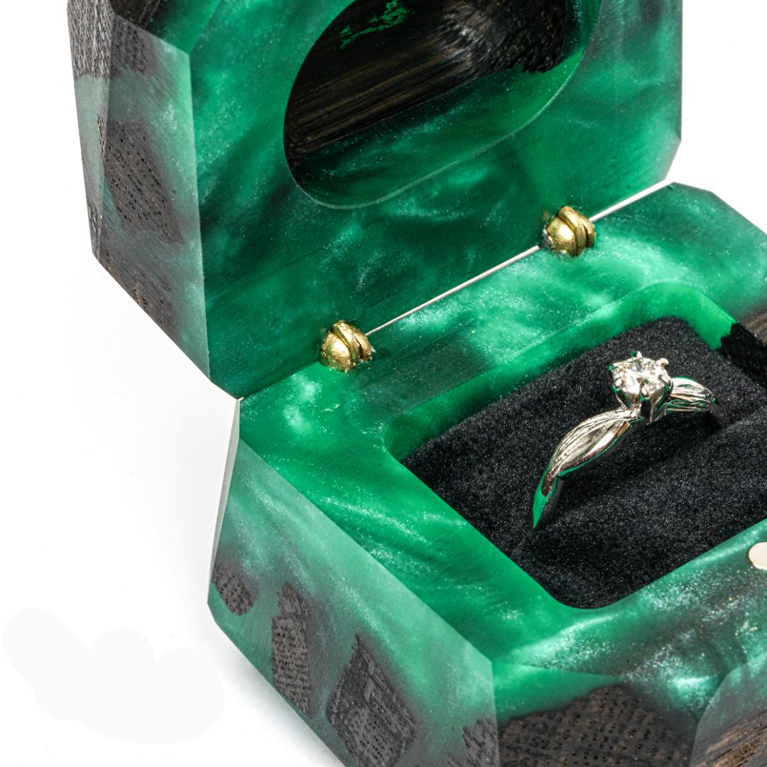 Close-up of the open green epoxy and bog oak wood engagement ring box interior with ring holder