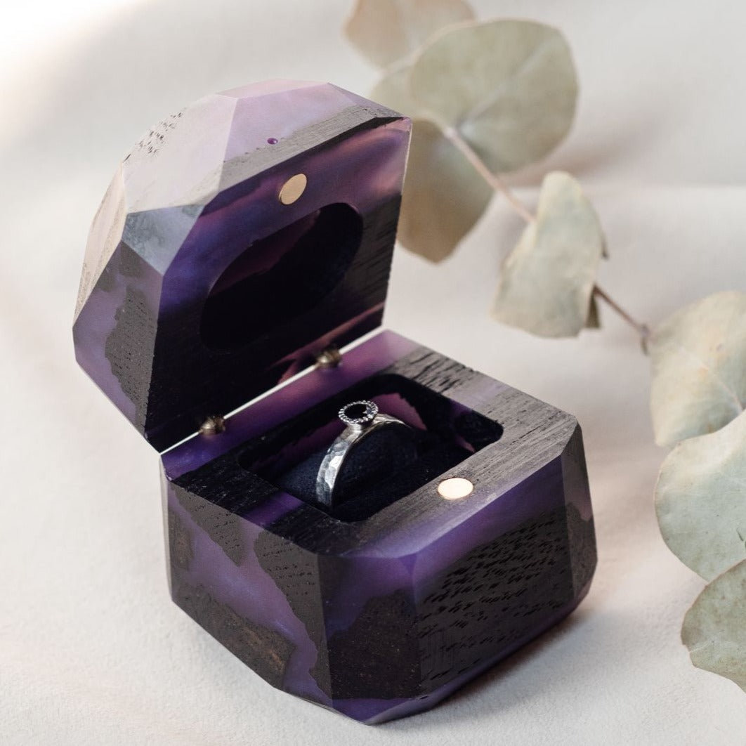 Angled front view of the open purple epoxy and bog oak proposal ring box, METEORITE