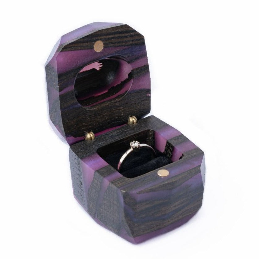 Side angle of the open purple epoxy and bog oak proposal ring box with ring holder